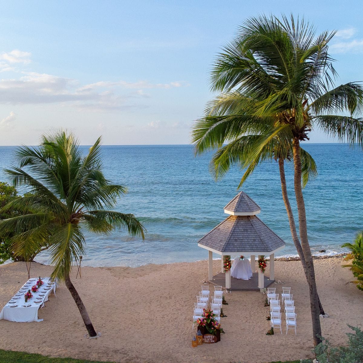 A white gazebo with a beach wedding setup, ideal for a romantic Caribbean destination wedding.