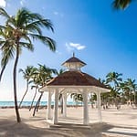White gazebo on sandy beach, ideal for a romantic destination wedding in the Dominican Republic.