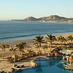 Resort pool lined with palm trees, perfect for a destination wedding or all-inclusive wedding package.