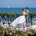 Bride and groom on a seaside deck, ideal for a destination wedding or large Jamaican weddings.