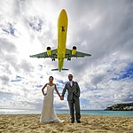 maho beach st maarten international airport couple posing with airplane