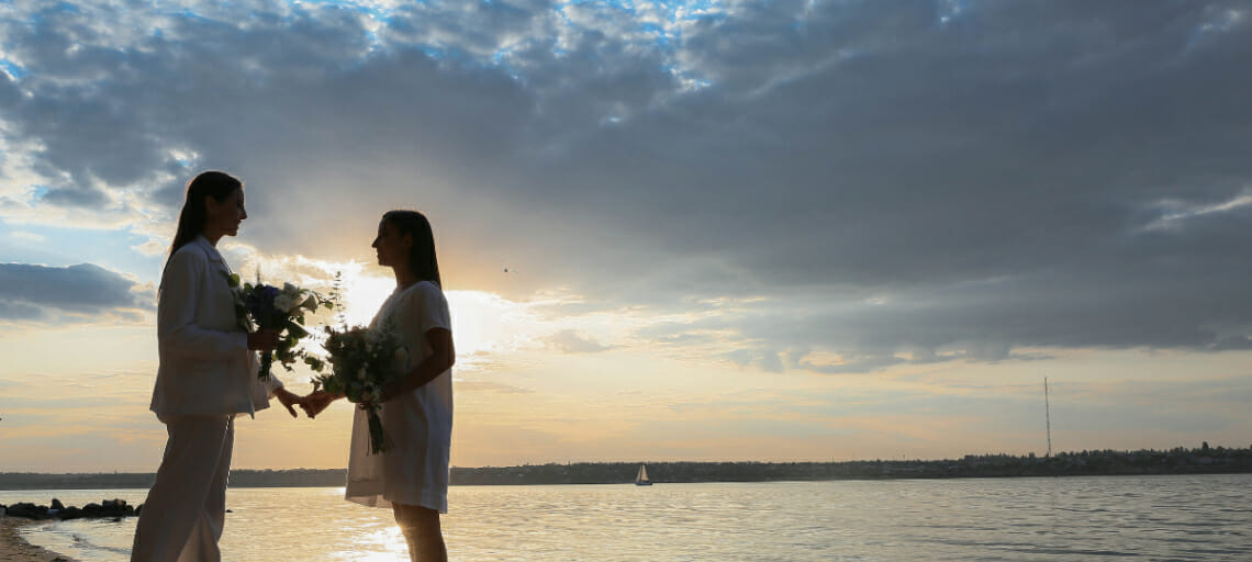 ways to make destination weddings more gender inclusive beach venue lgbtq couple