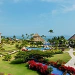 Resort grounds with gardens, pools, palm trees—perfect destination wedding views at Panama Jack Cancun.