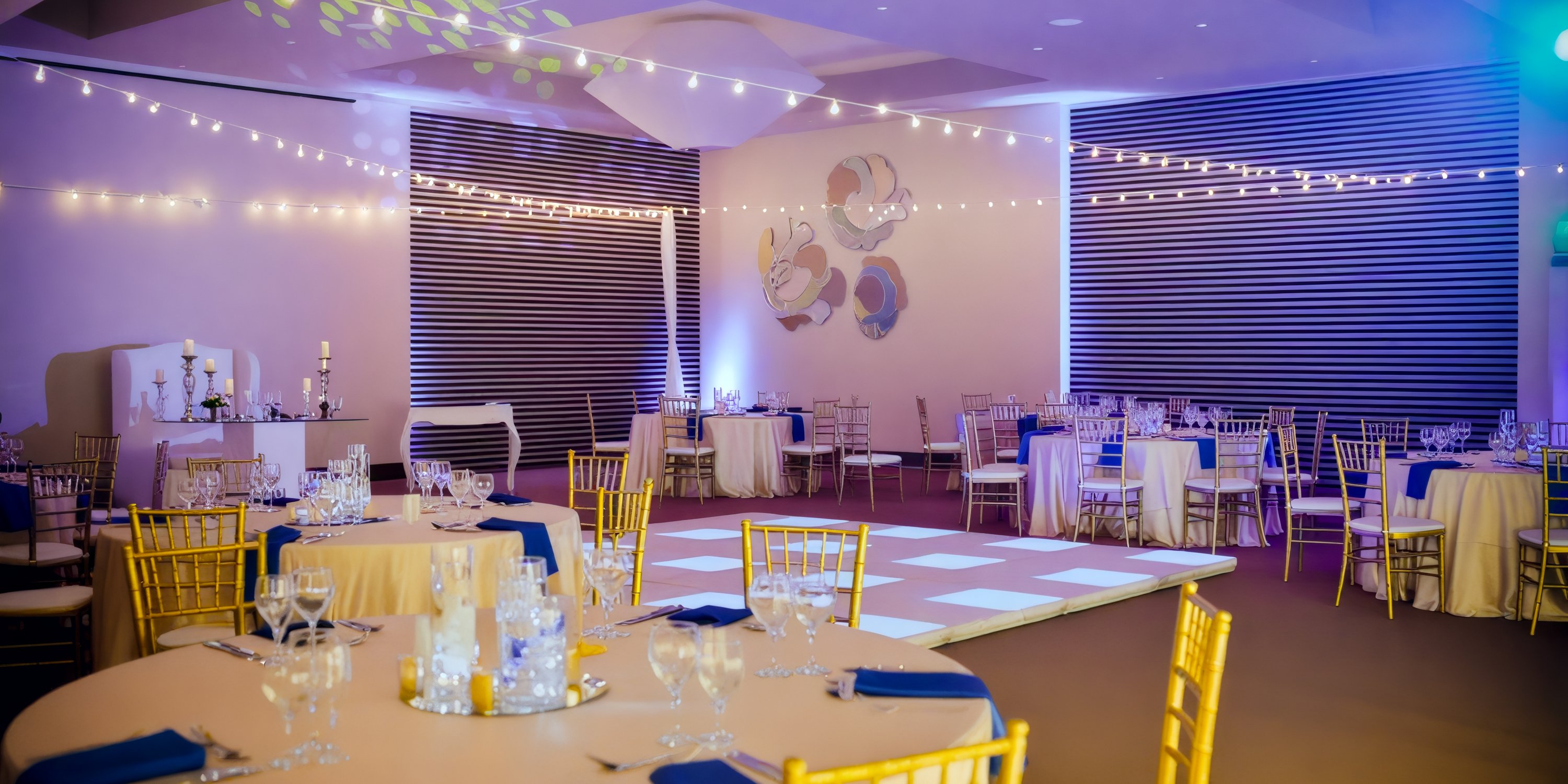 Event space at Breathless Punta Cana Resort: round tables, elegant chairs, enchanting string lights—perfect for a destination wedding.