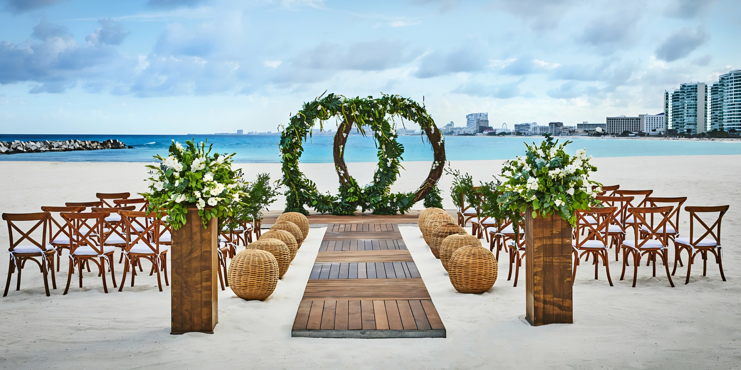 Hyatt Ziva Cancun with floral arch and seating against an urban skyline backdrop.