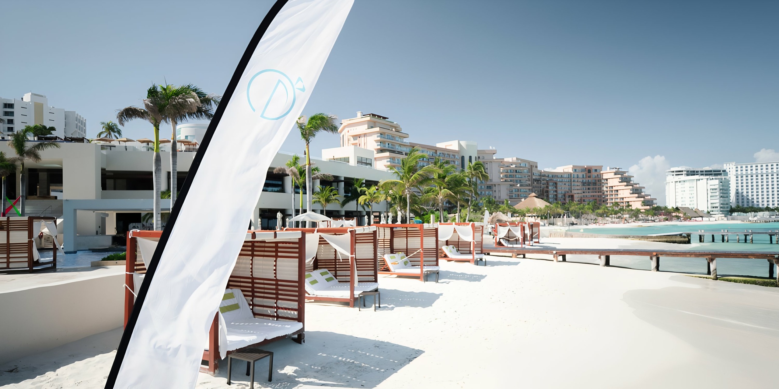 Hyatt Ziva Cancun resort with loungers and modern architecture on a sunny day.