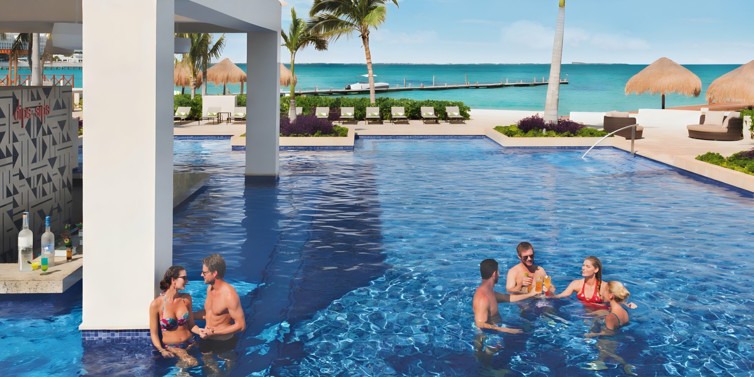 People enjoying drinks in a swim-up bar at Hyatt Ziva Cancun resort pool.