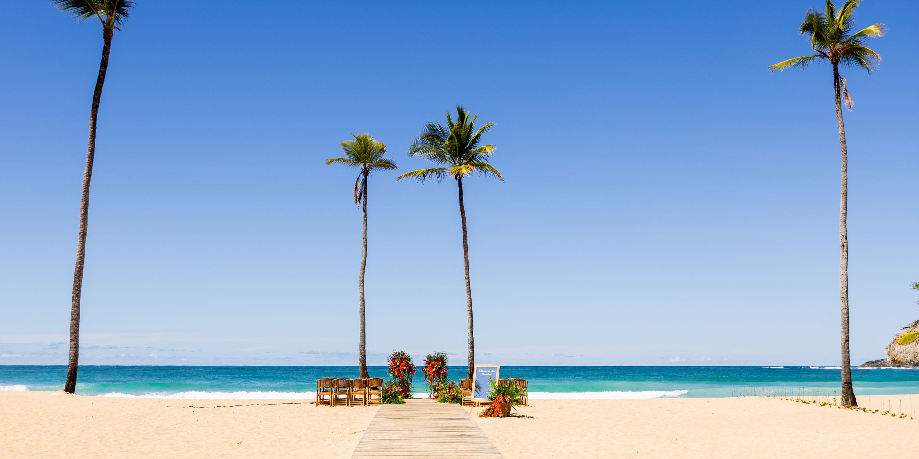 Wooden walkway on sandy beach at Dreams Macao Beach, perfect for a destination wedding by the ocean.