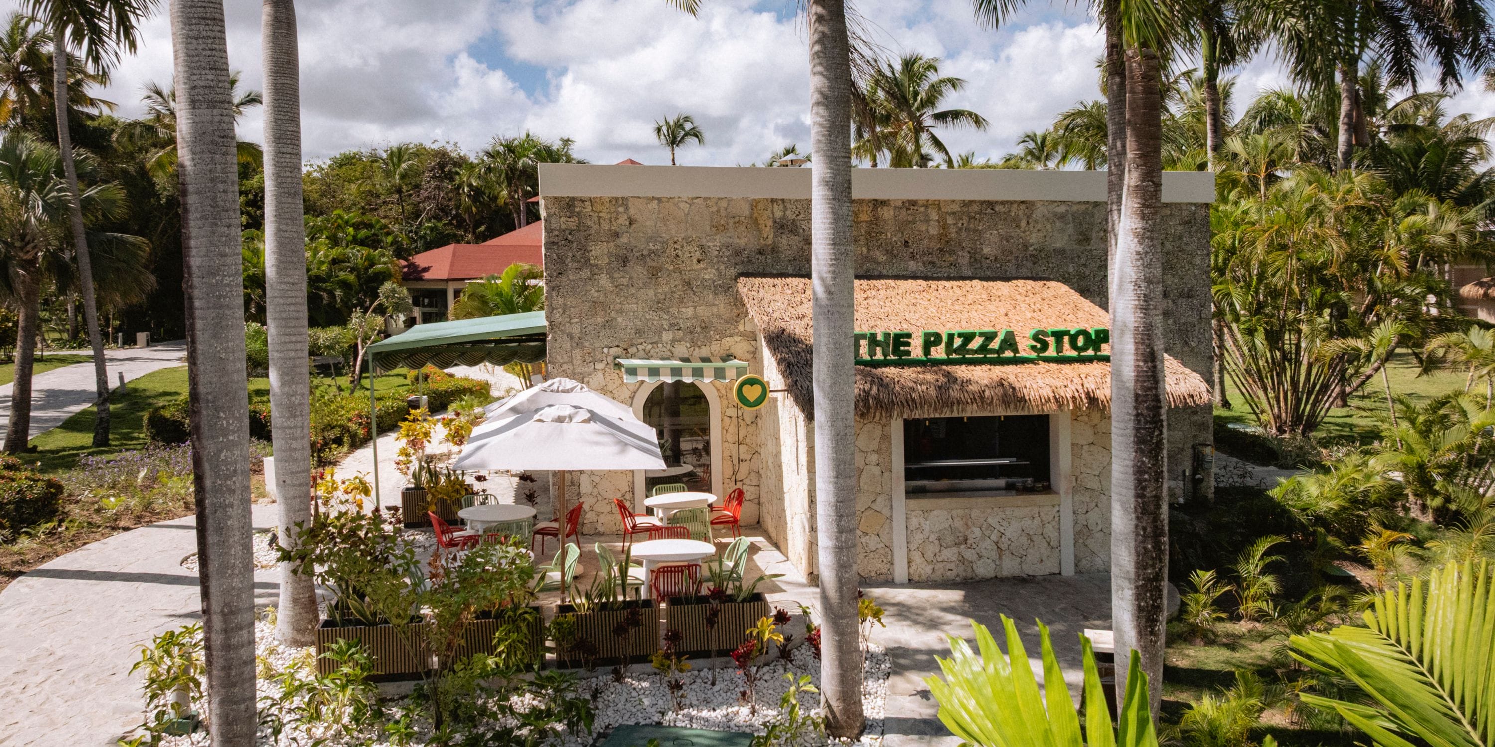 Outdoor pizza spot at Grand Palladium Bavaro, ideal for a destination wedding among palms and greenery.