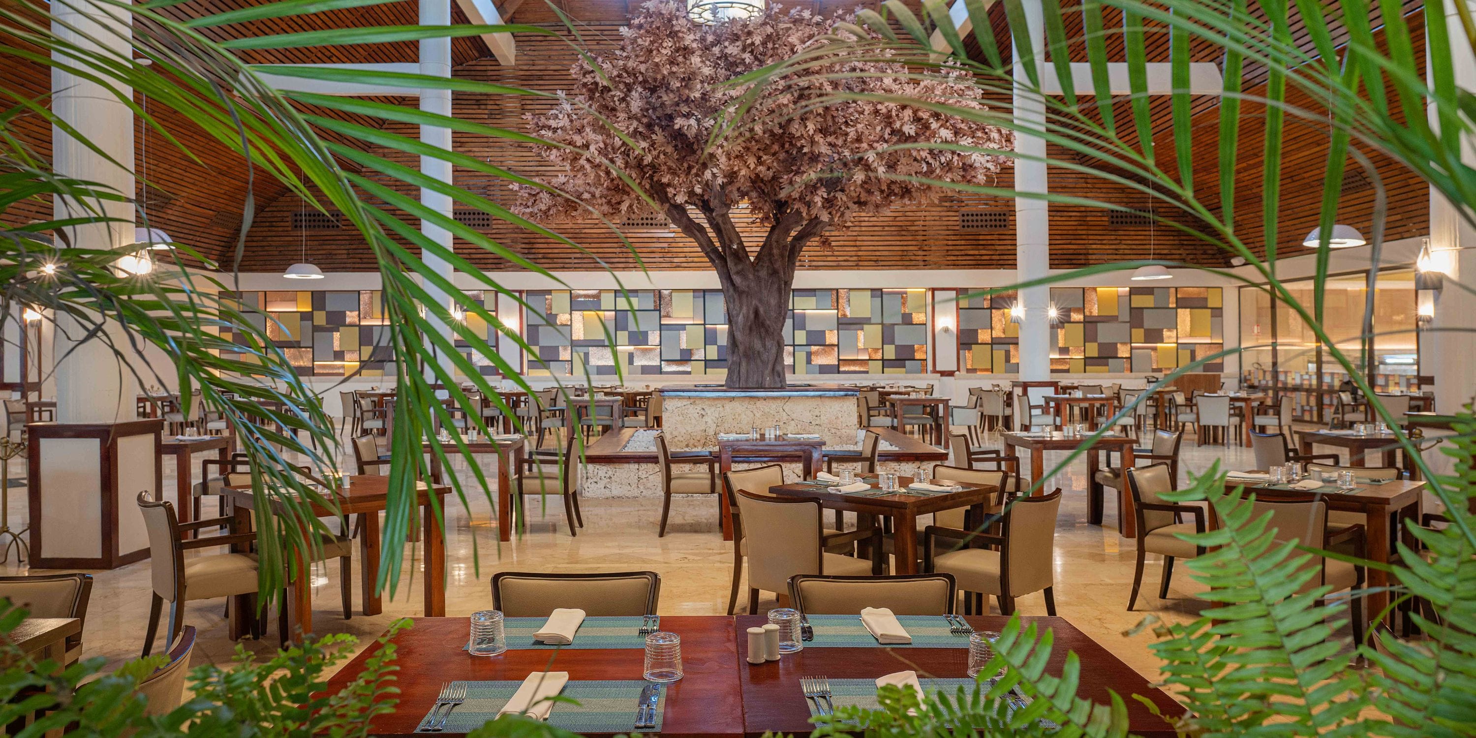 Grand Palladium Bavaro offers ample seating, a faux tree, and lush plants—ideal for a destination wedding.