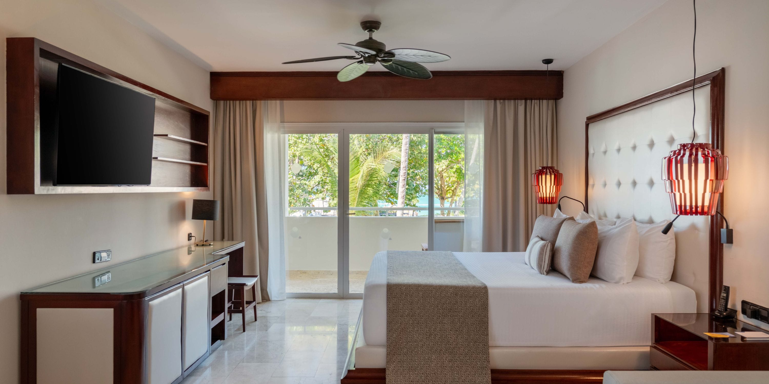 Grand Palladium Bavaro room perfect for a destination wedding: large bed, desk, TV, and balcony views.