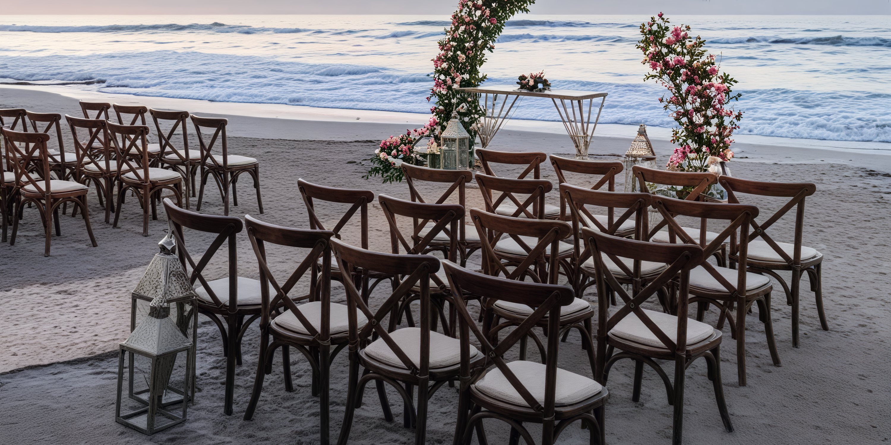 Destination wedding at Grand Palladium Vallarta: featuring wooden chairs, floral arches, and a stunning ocean view.