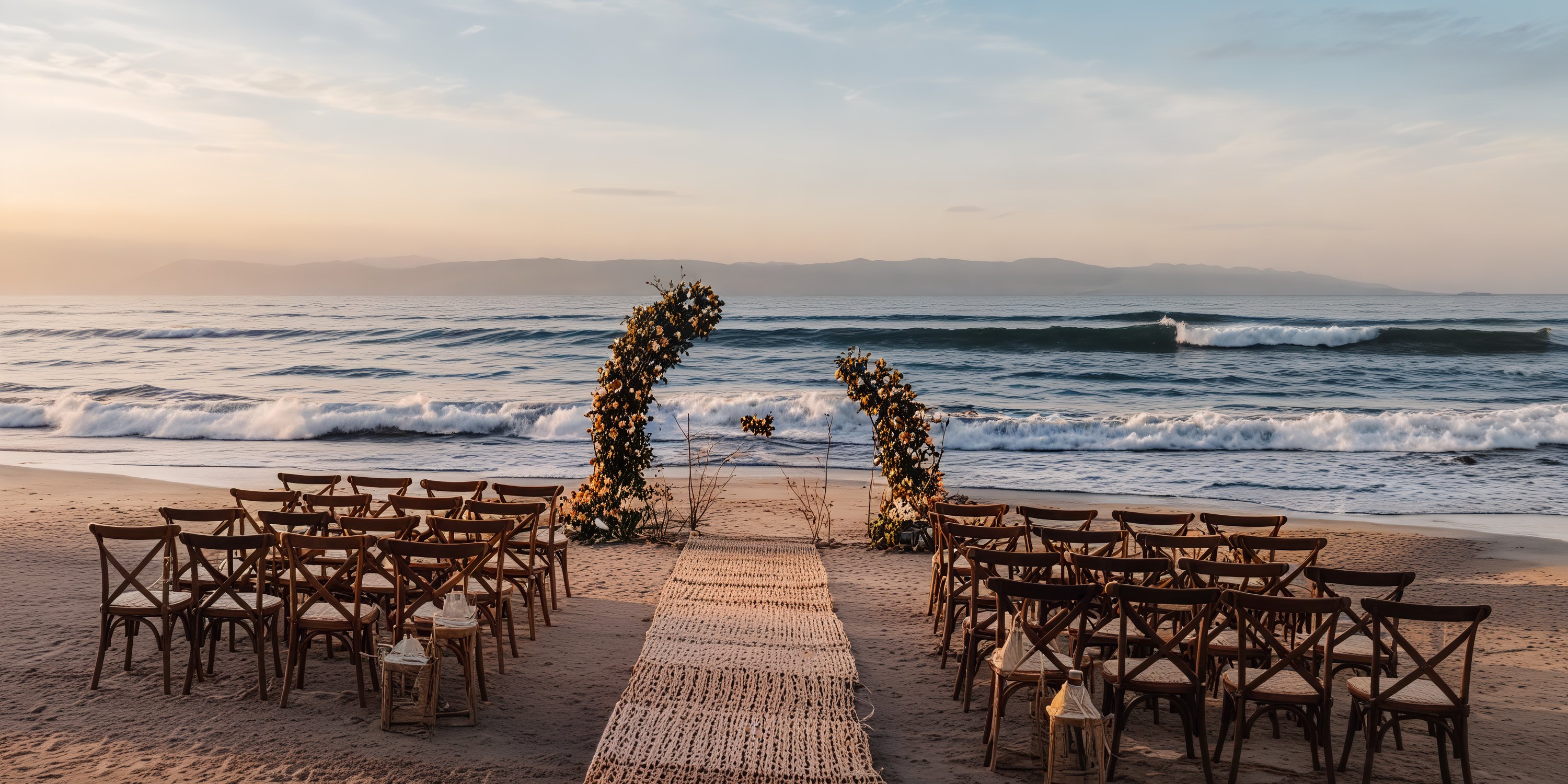Sunset destination wedding setup featuring chairs and floral arches at Grand Palladium Vallarta.