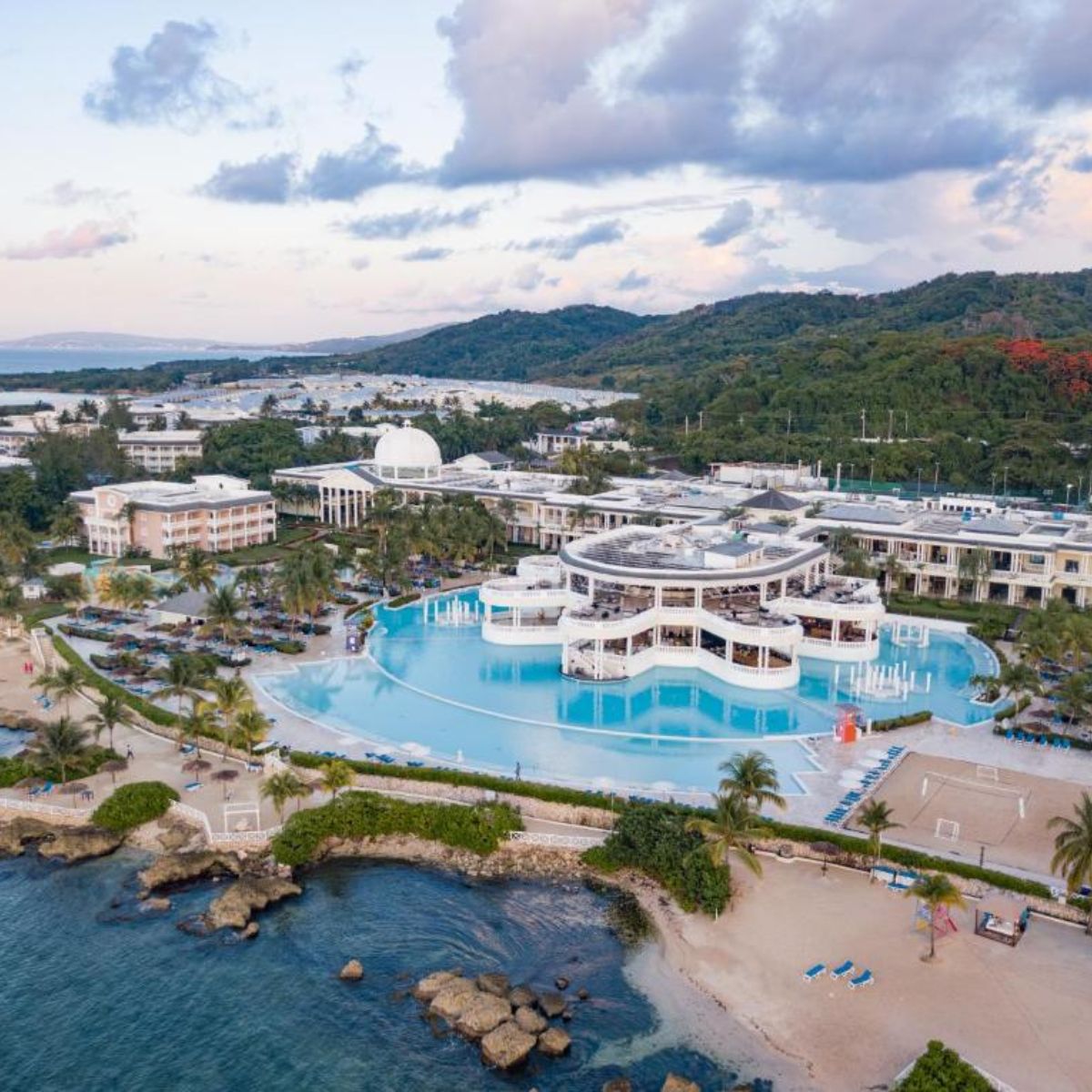 Aerial view of Grand Palladium Jamaica, an ideal destination wedding spot with a central pool and palms.