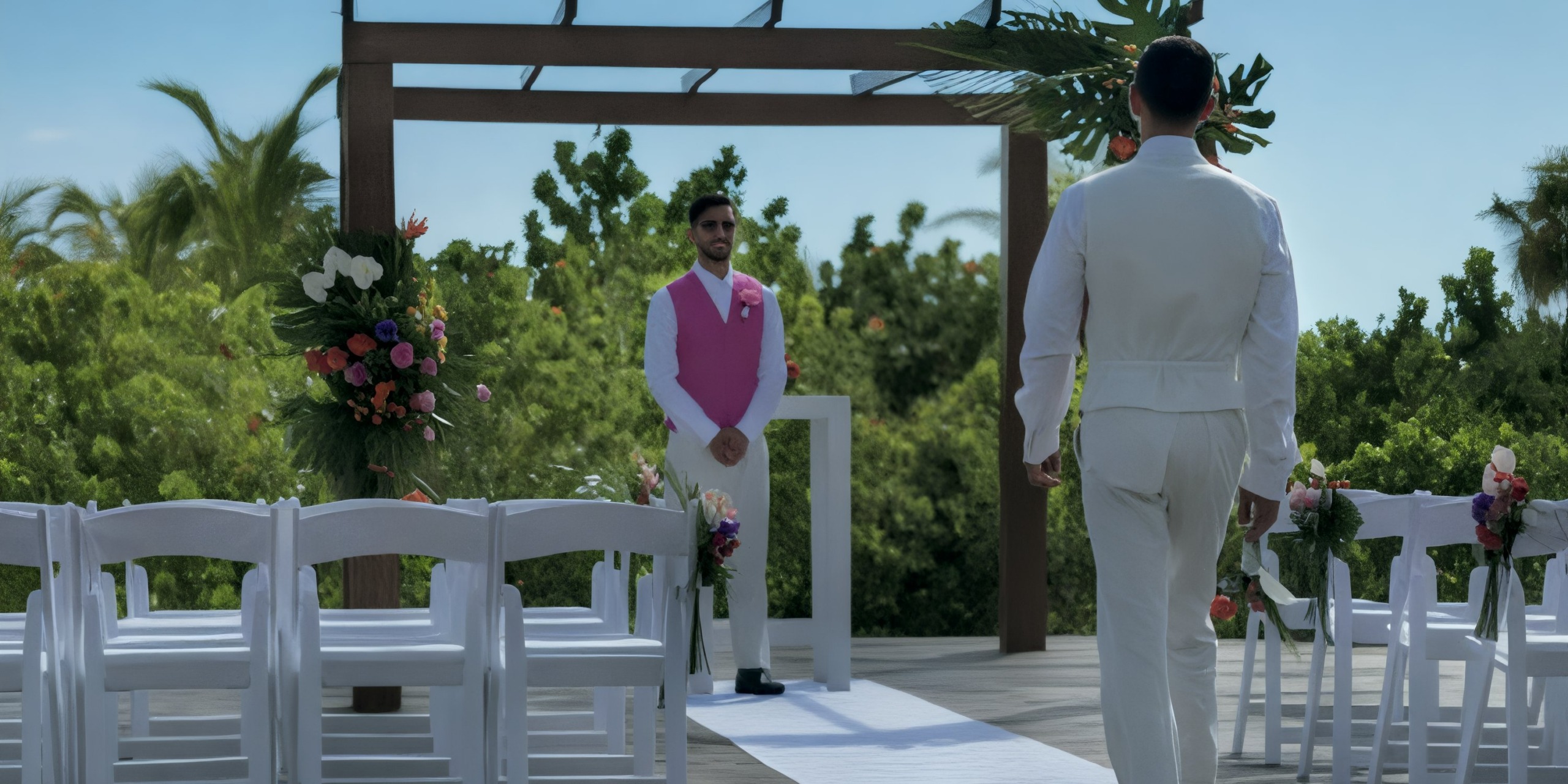 Two men make their way down the aisle at a beautiful outdoor destination wedding held at the Grand Palladium Costa Mujeres.