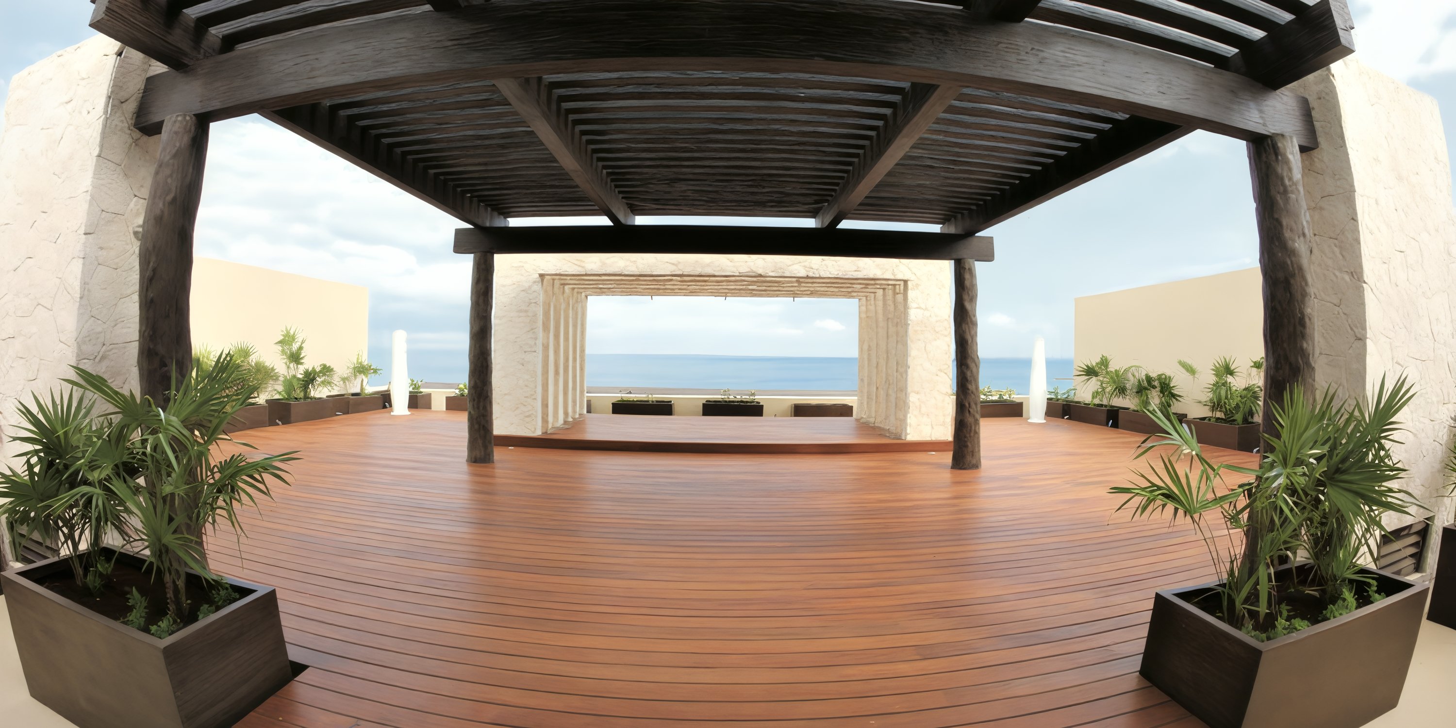 Open wooden terrace with a large pergola, potted plants, and an ocean view—ideal for a destination wedding.
