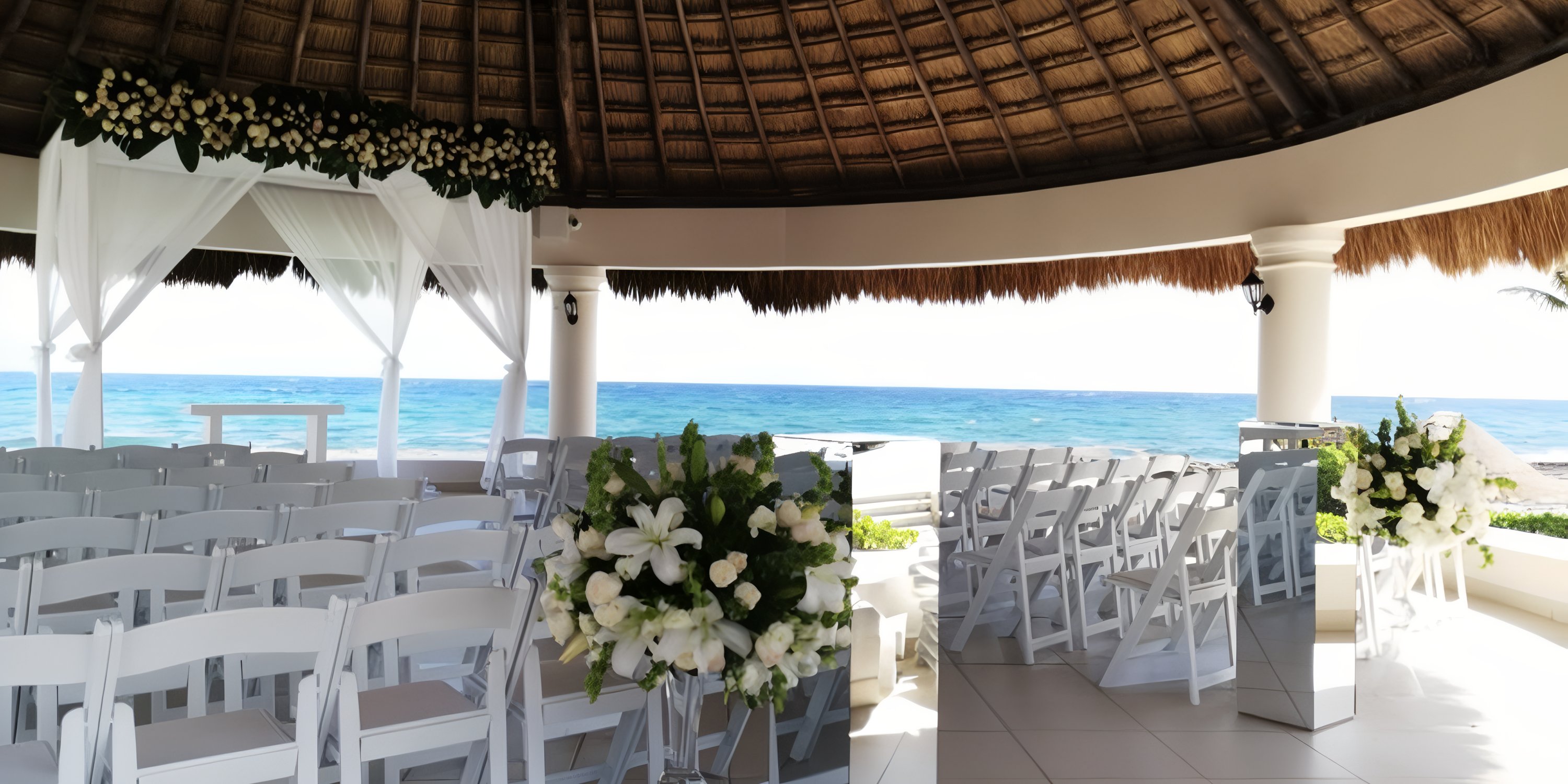 White chairs and florals arranged for a destination wedding at Hard Rock Riviera Maya beachside setup.