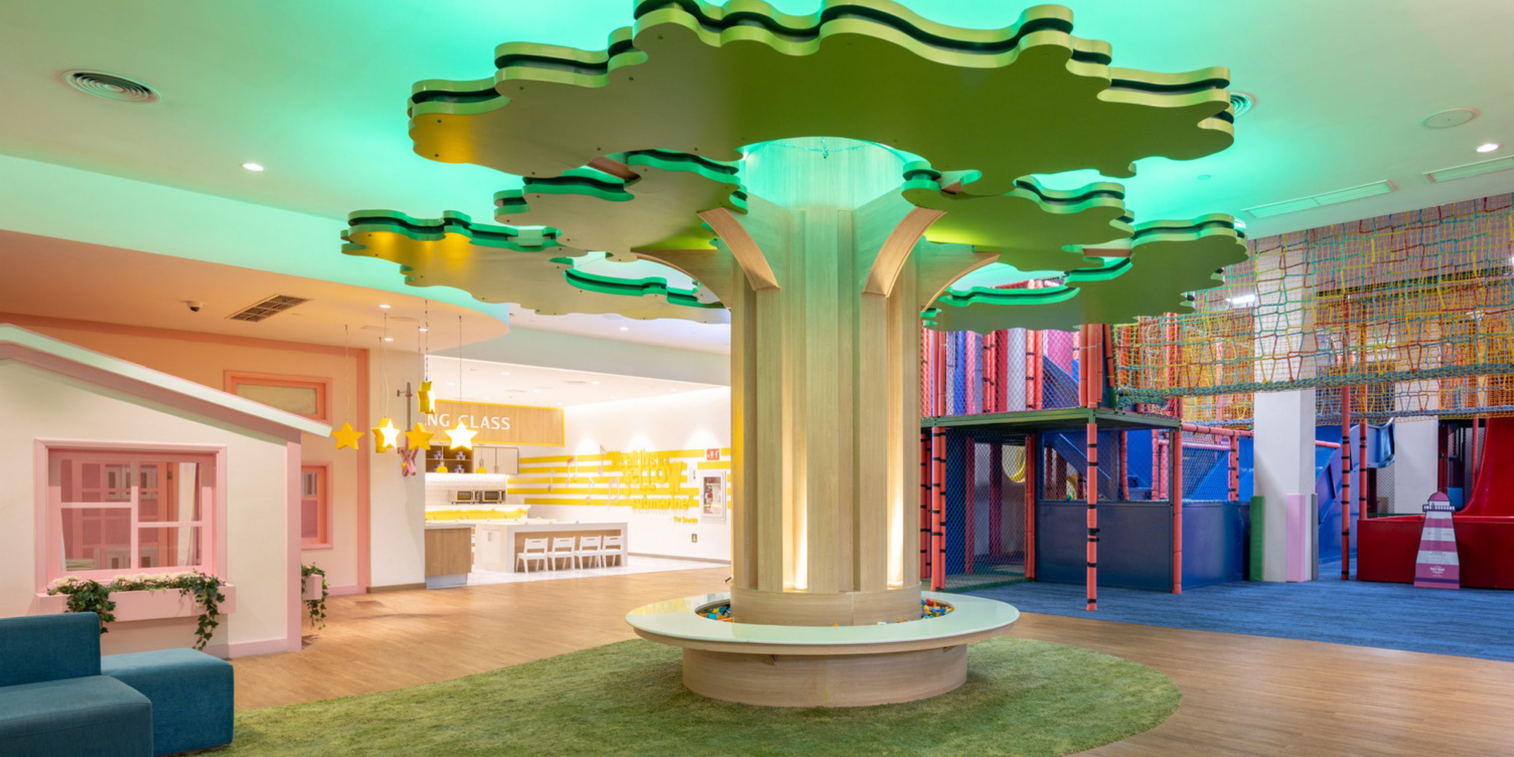 Hard Rock Punta Cana, an ideal destination wedding venue, boasts an indoor play area featuring a central tree and vibrant, colorful equipment.
