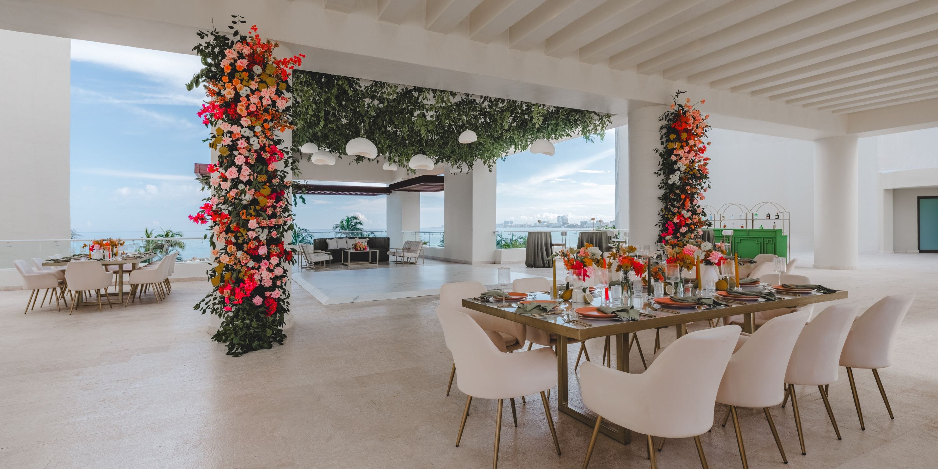 Hyatt Ziva Cancun: Elegant wedding venue featuring decorated tables and columns with floral arrangements.
