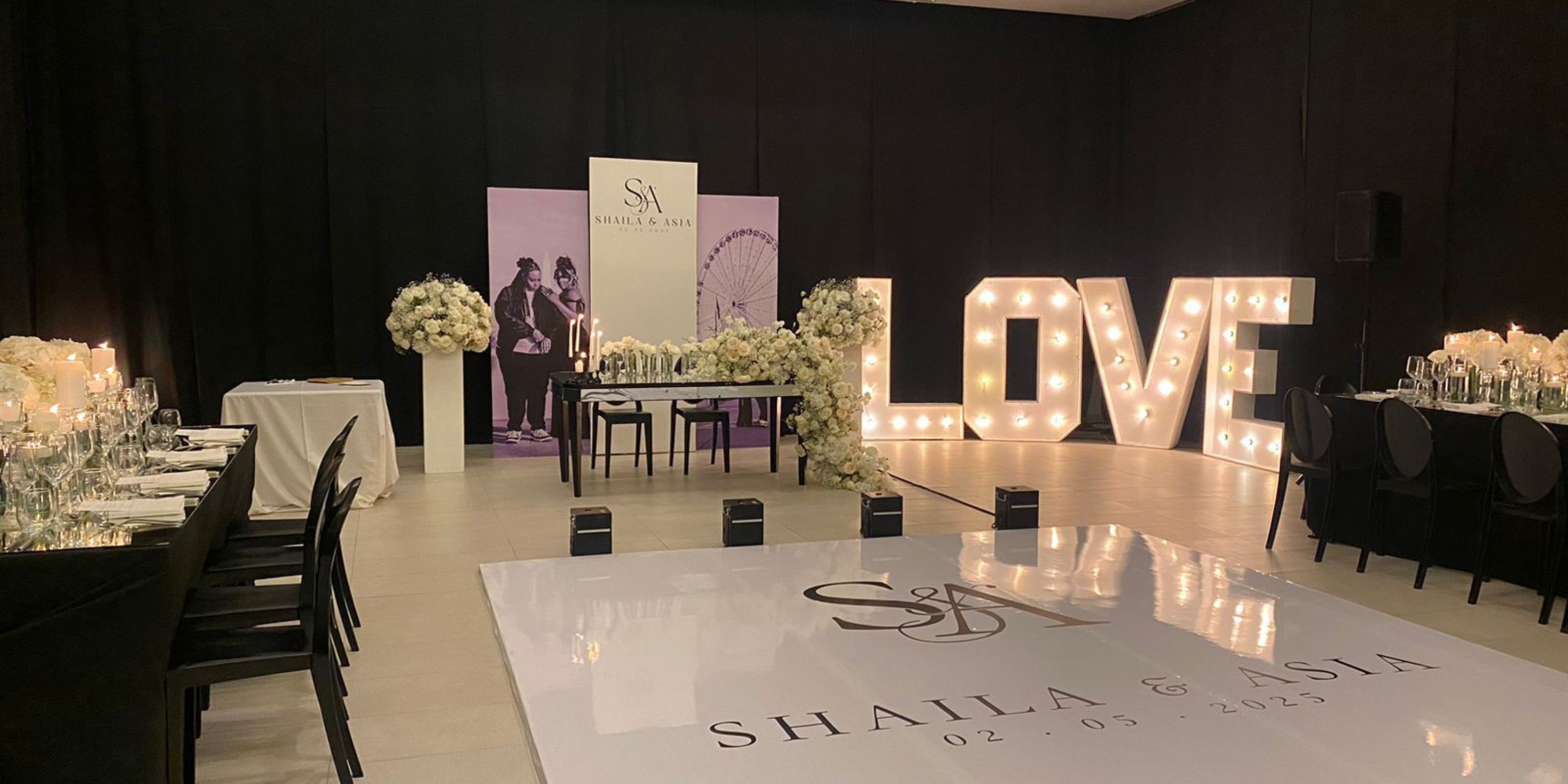 Majestic Elegance Costa Mujeres wedding hall featuring florals, "LOVE" marquee, and "Shaila & Asia" floor.