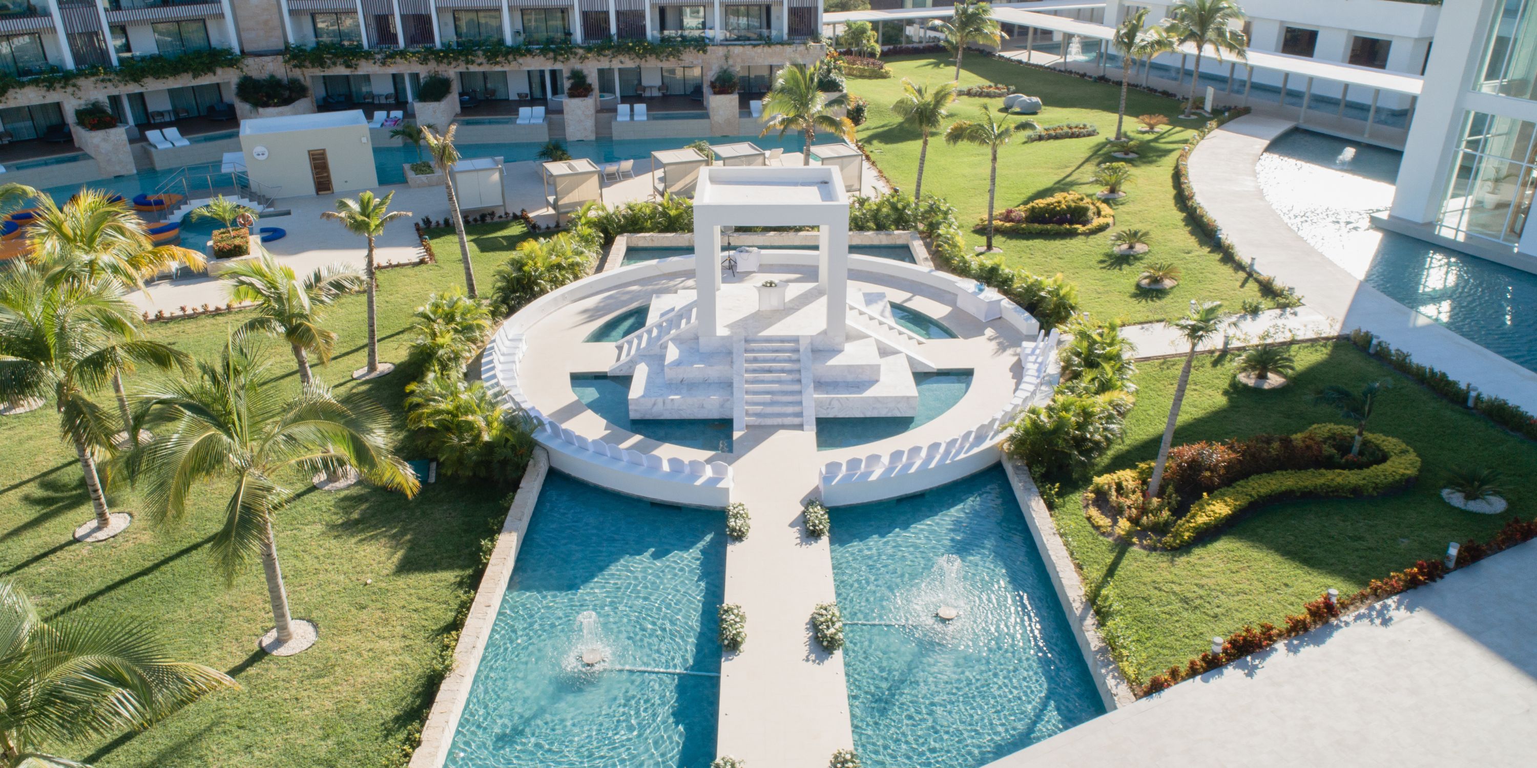Aerial view of Majestic Elegance Costa Mujeres, a stunning destination wedding venue with water features.