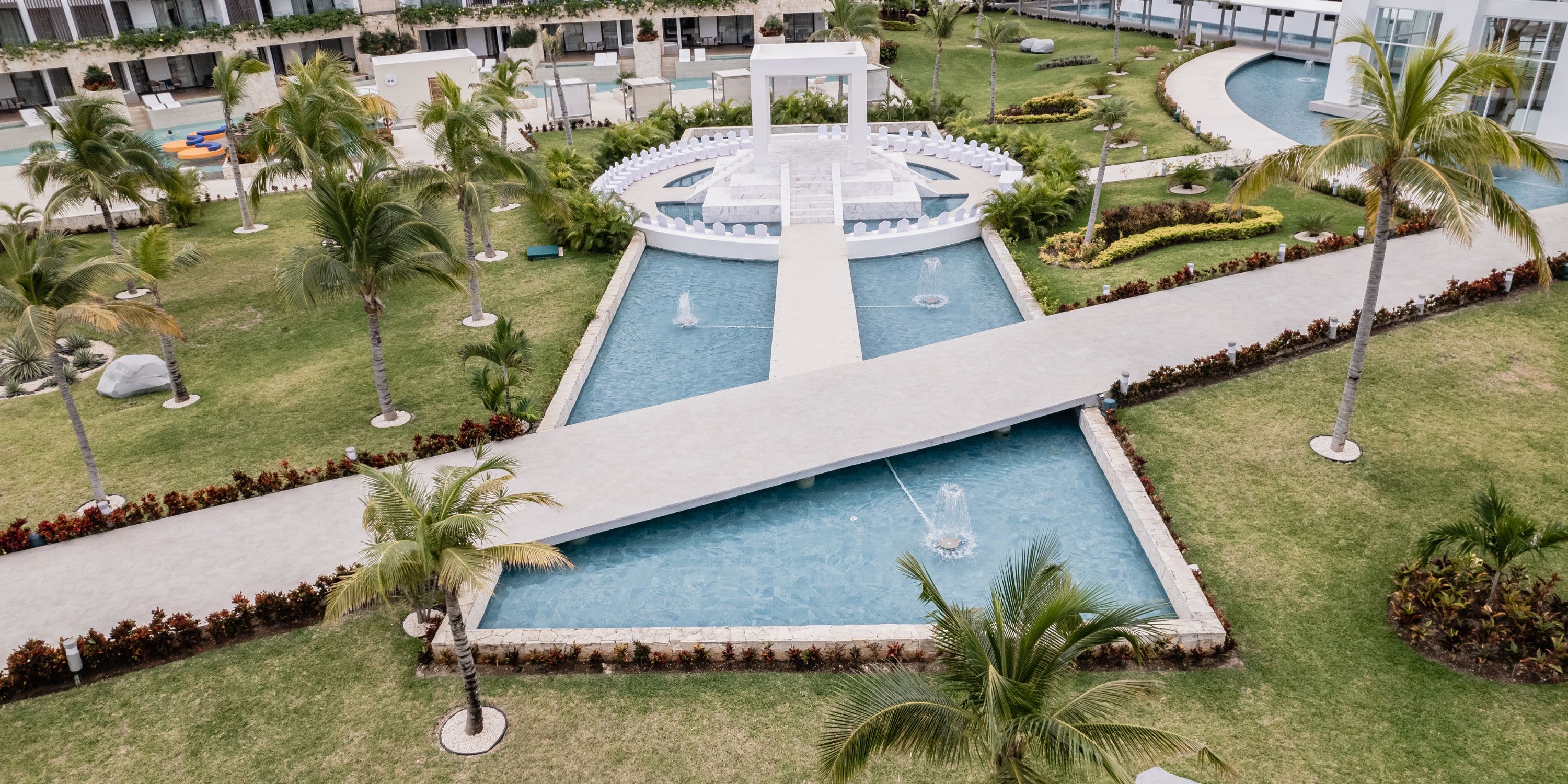 Aerial view of Majestic Elegance Costa Mujeres, ideal for a destination wedding amid gardens and water features.
