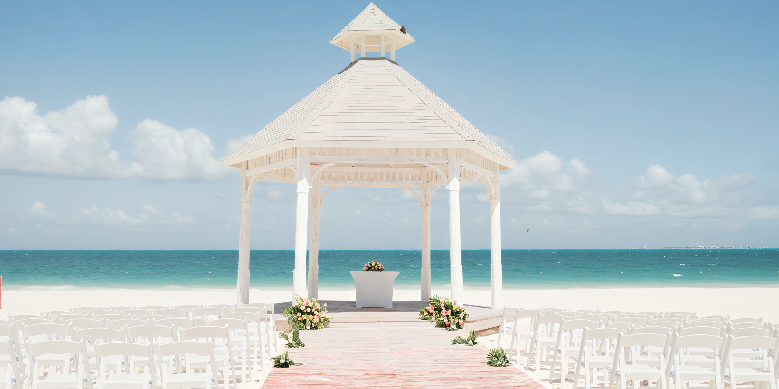 Majestic Elegance Costa Mujeres beach adorned with a beautifully arranged gazebo and chairs, perfect for a destination wedding celebration.