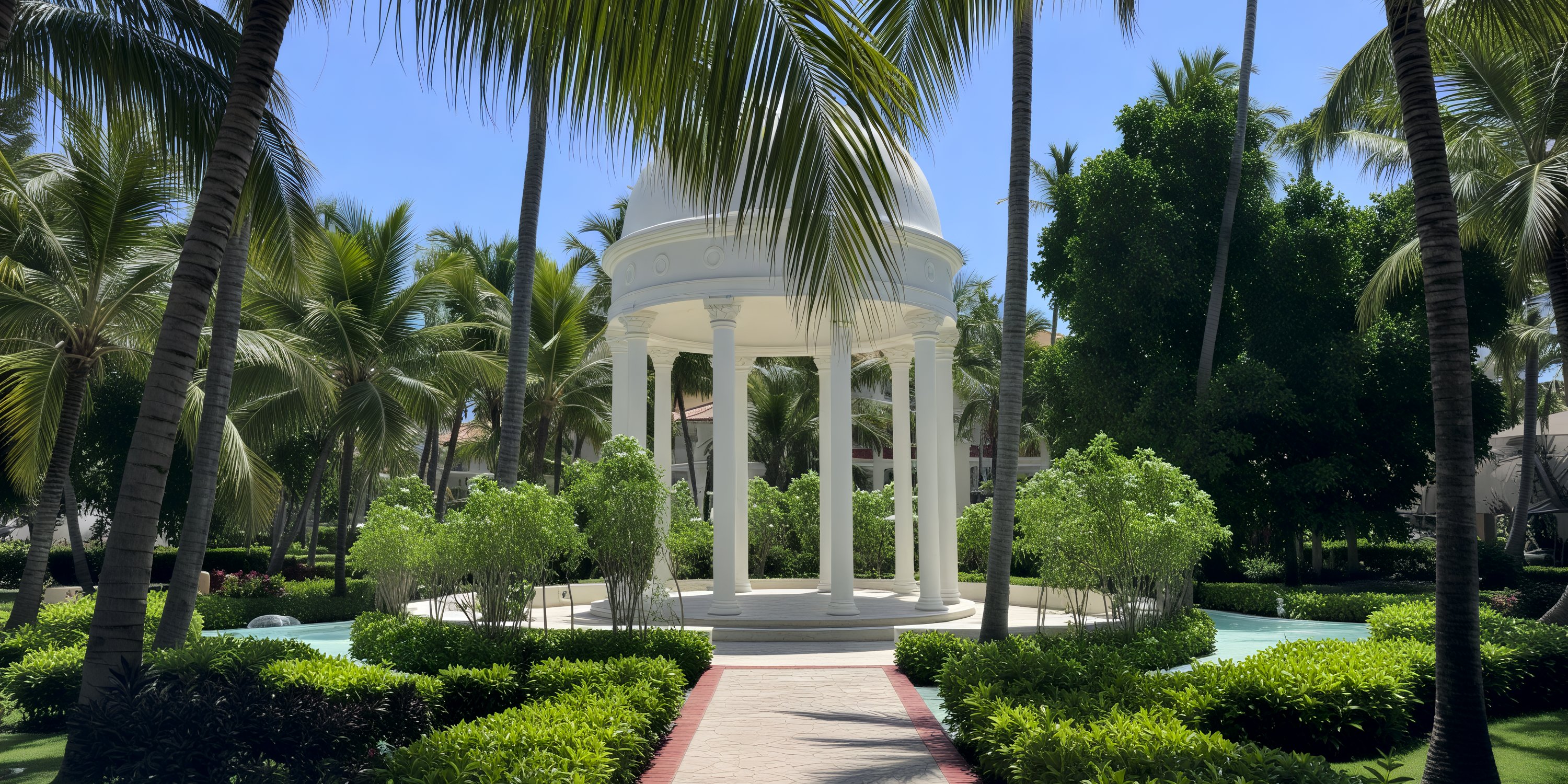 A white gazebo nestled amidst lush greenery and towering palm trees creates a picturesque setting for a destination wedding in the tropics.