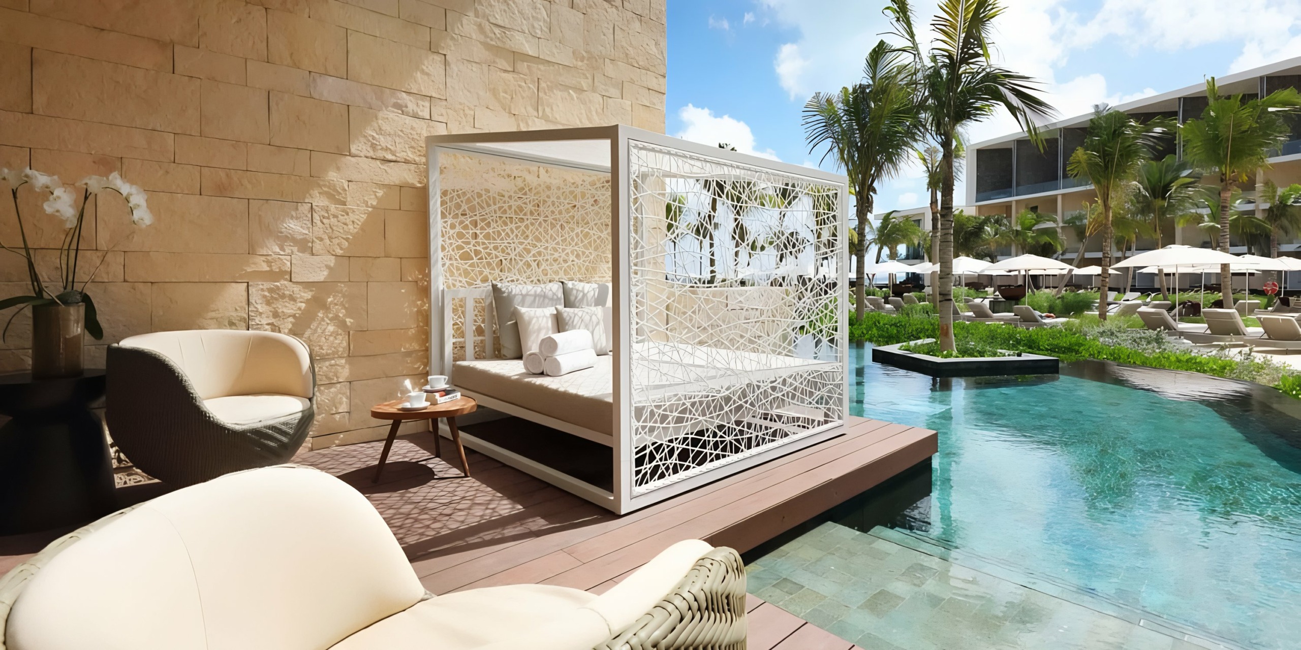 Luxurious poolside relaxation area at Grand Palladium Costa Mujeres with modern outdoor furniture and tropical setting.