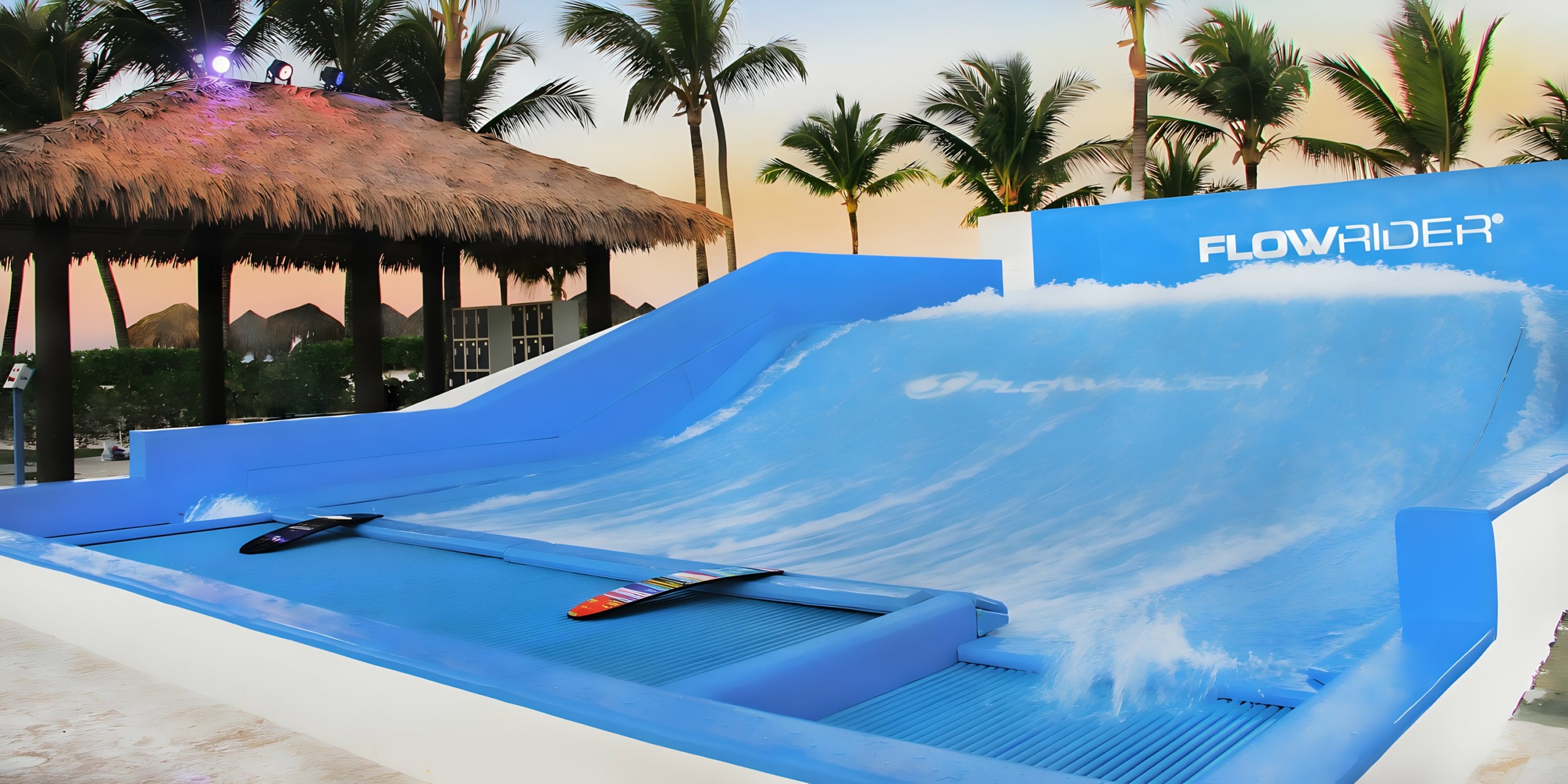A Hard Rock Punta Cana flowrider surf simulator with boards at the resort during twilight.