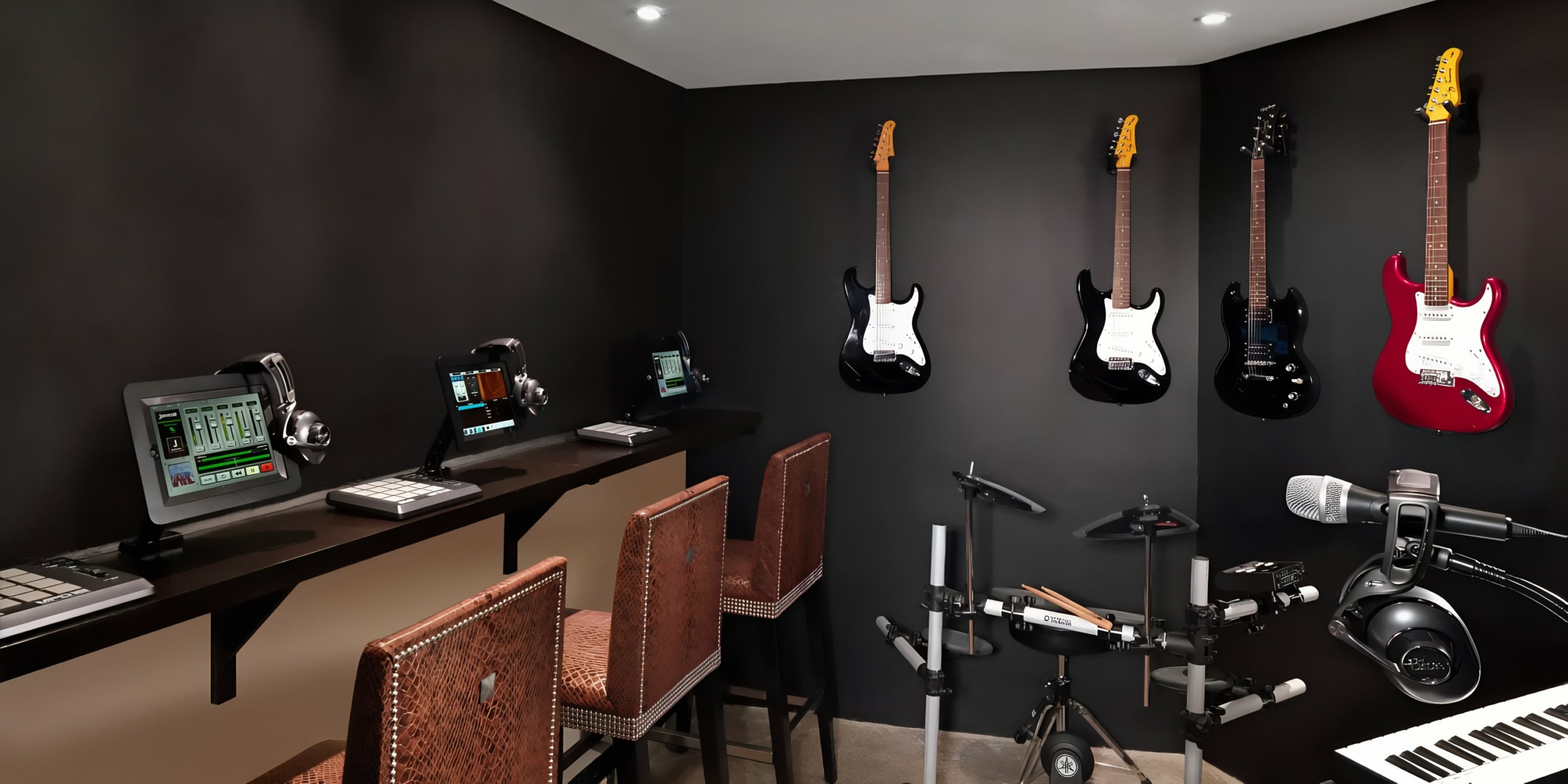 A Hard Rock Punta Cana with guitars mounted on a wall, musical equipment, and digital audio workstations.