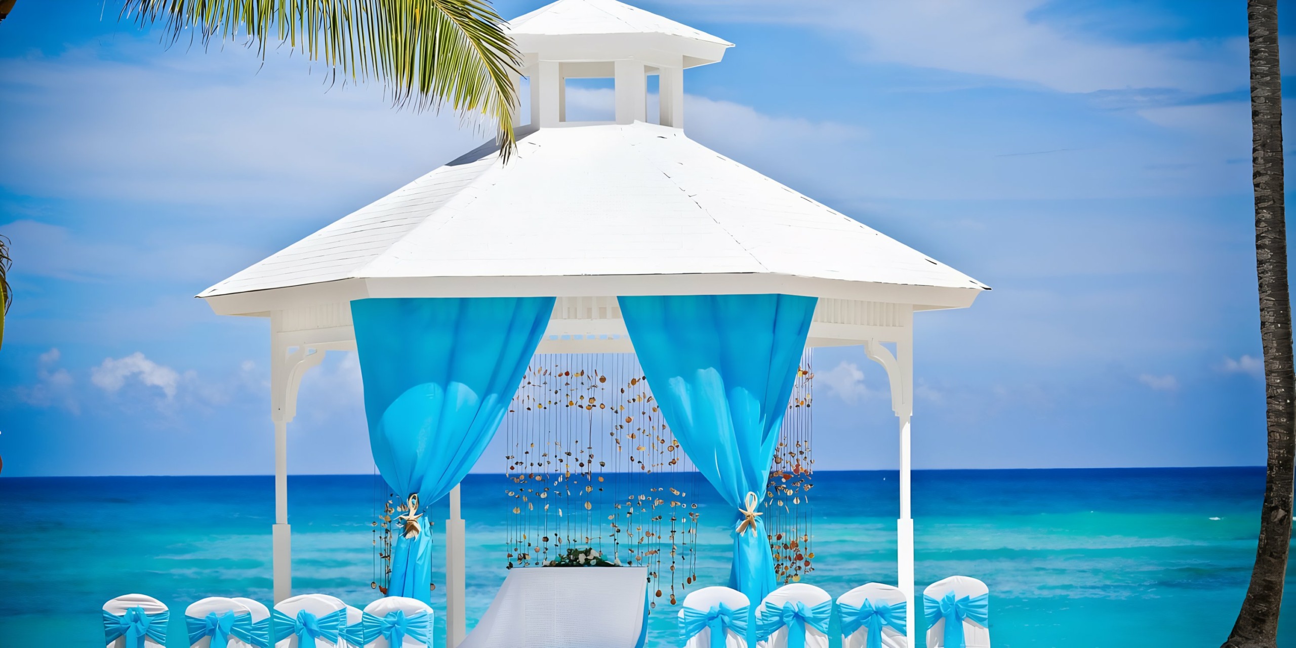 Majestic Elegance Punta Cana wedding gazebo with white and blue decorations overlooking the ocean.