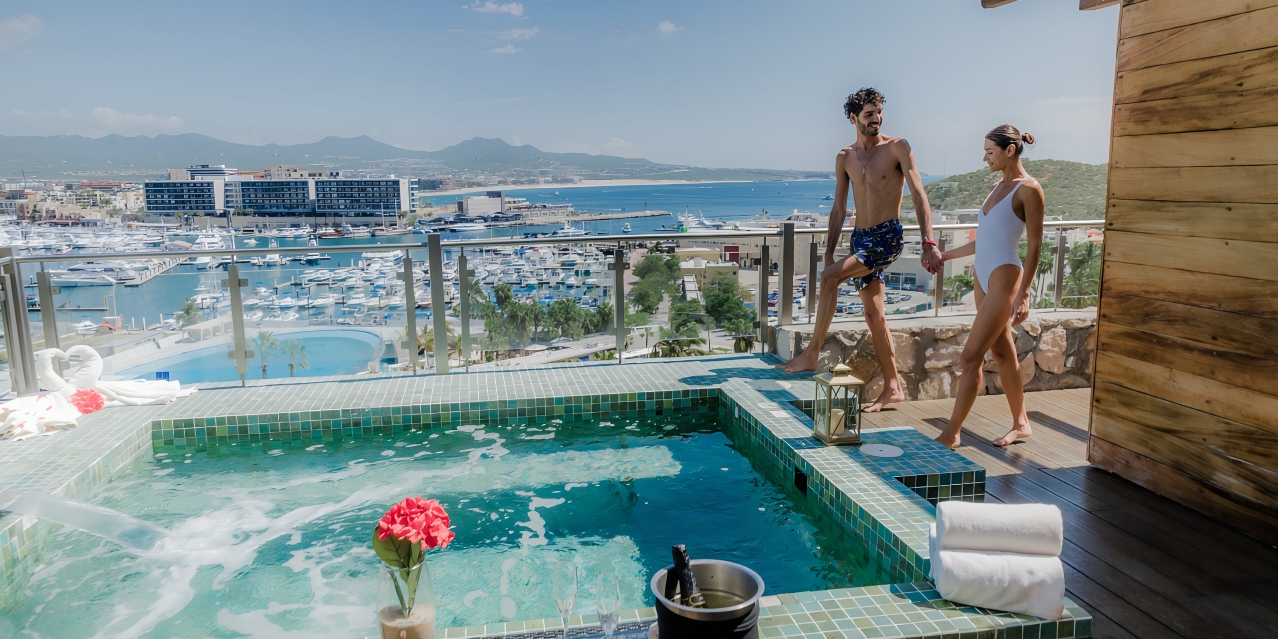 A couple enjoying a luxury spa with a scenic view of Sandos Finisterra Los Cabos and mountains in the background.