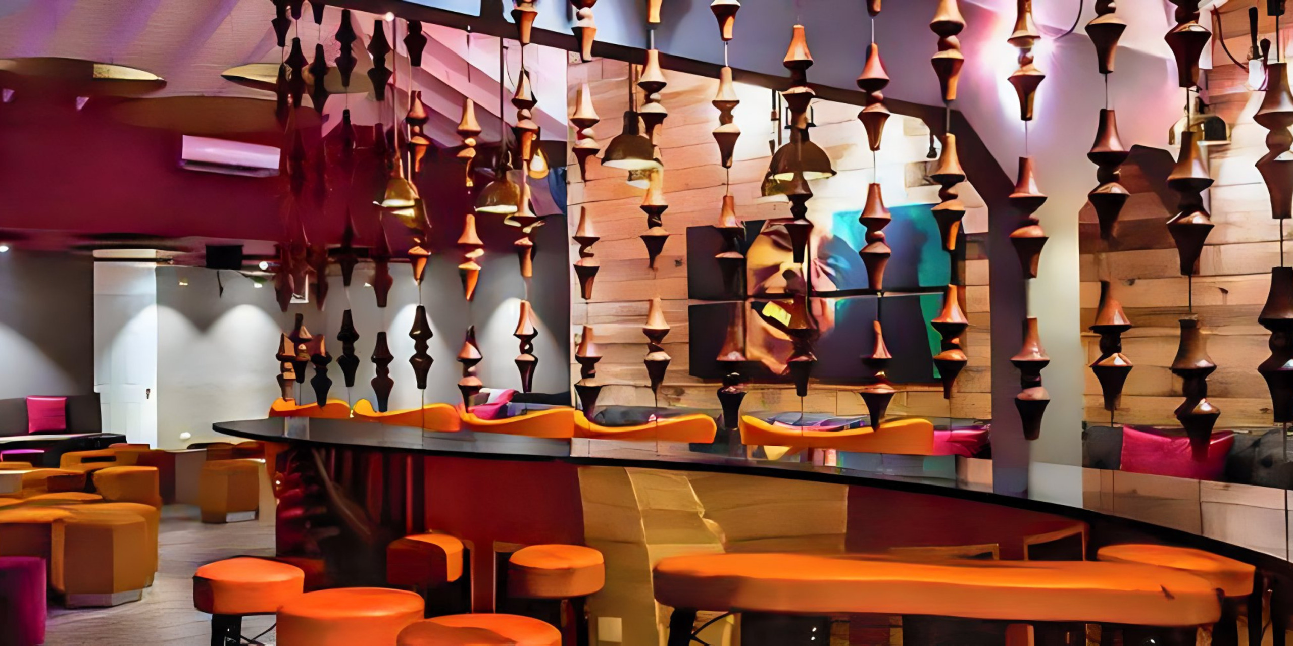 Colorful modern bar interior with orange stools, suspended geometric wooden decor, and vibrant purple lighting, perfect for destination weddings.