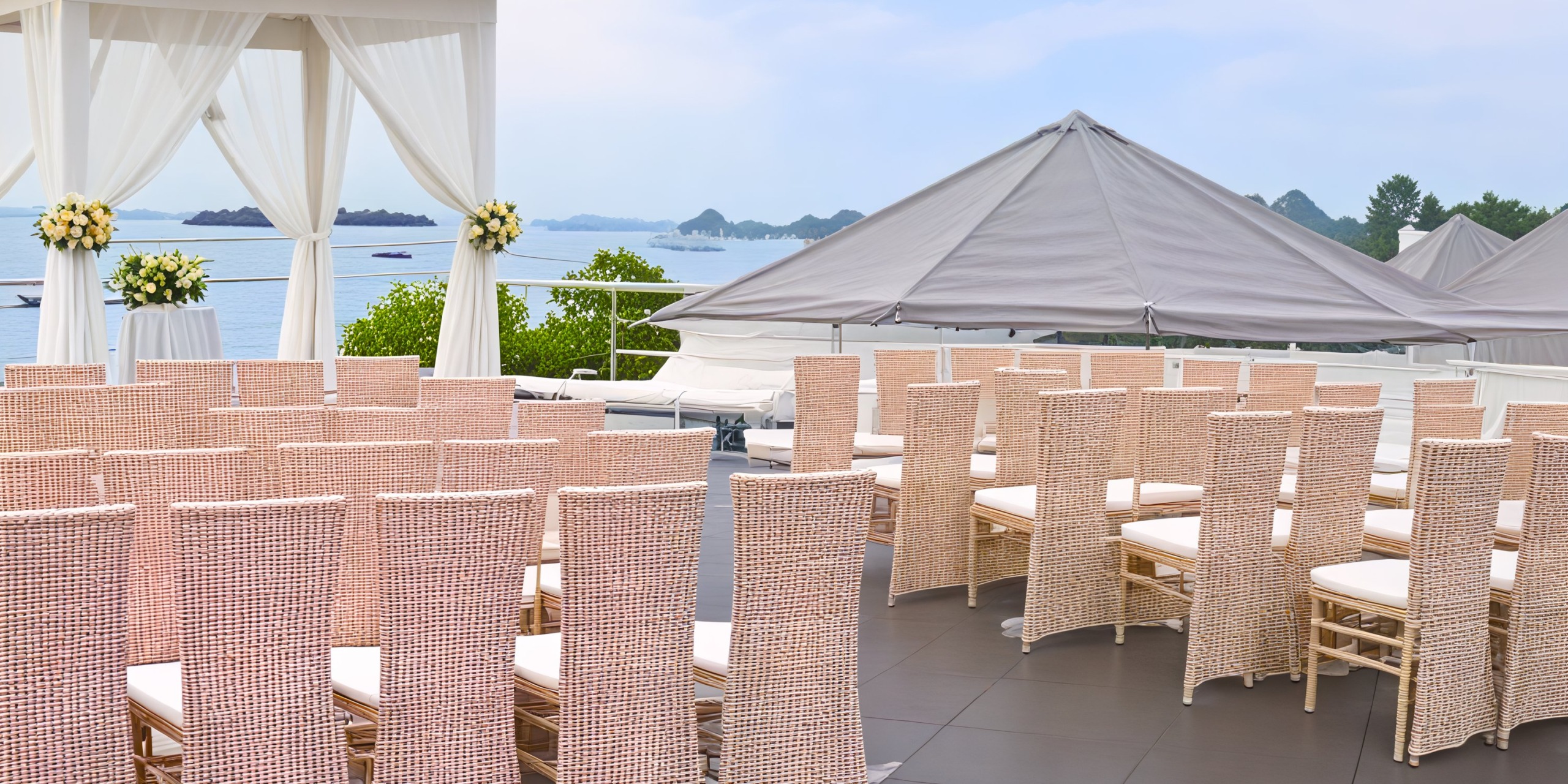 Azul Beach Resort Negril: A destination wedding by the sea featuring wicker chairs and a charming canopy.