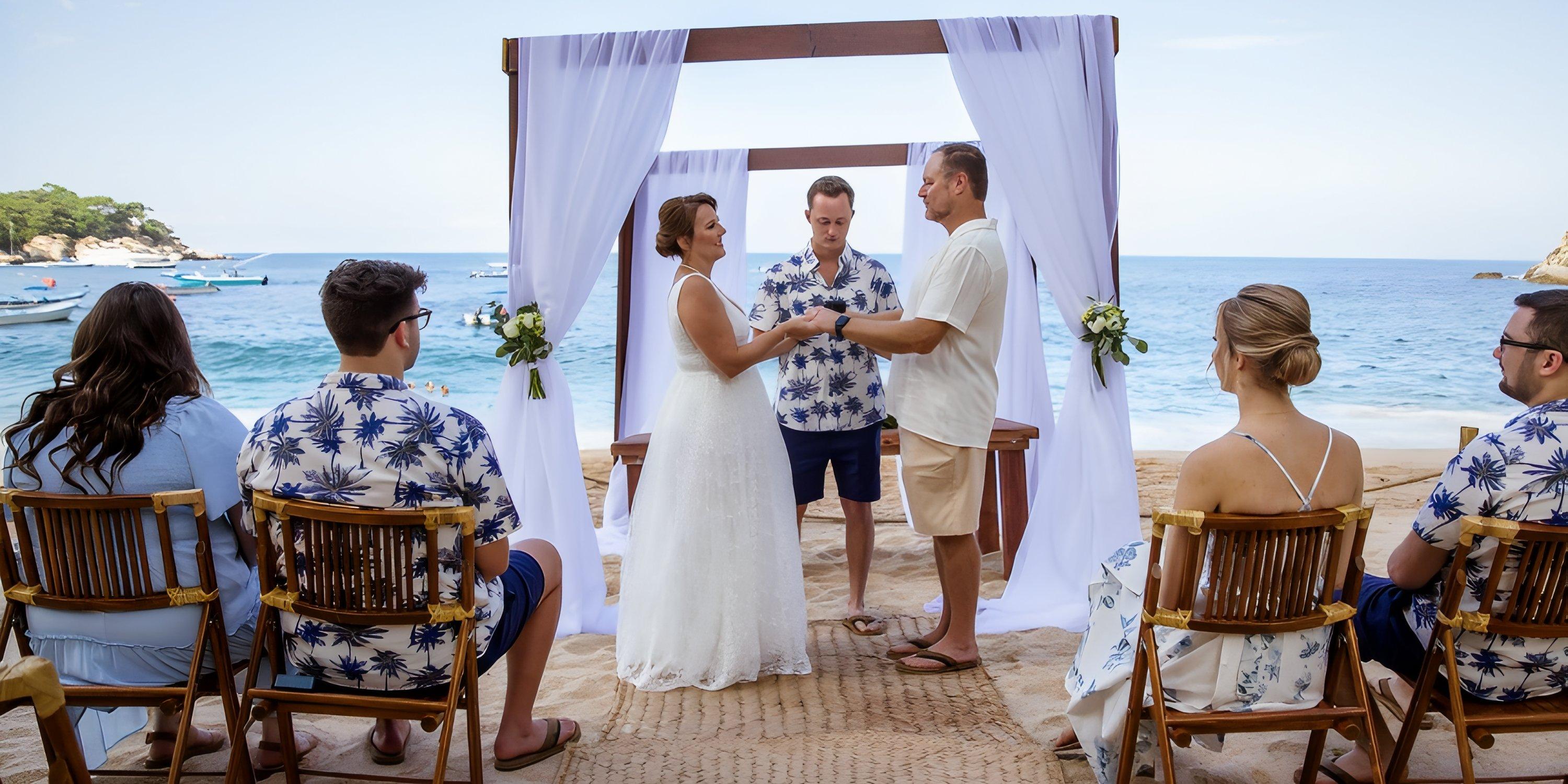 A destination wedding by the sea at Barcelo Puerto Vallarta, with guests seated near the couple.