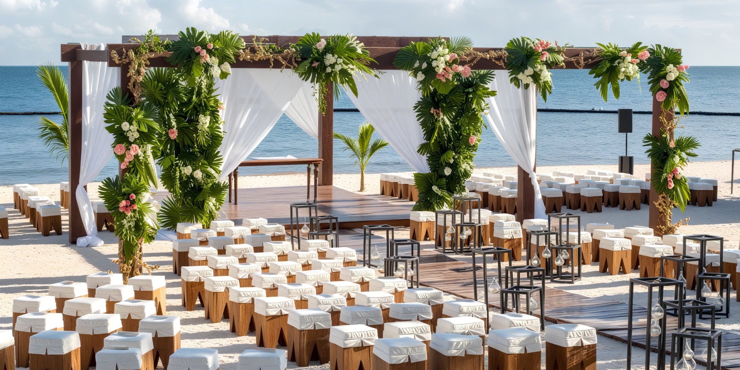 Destination wedding setup at Breathless Riviera Cancún Resort, featuring a charming arch, elegantly arranged chairs, and a breathtaking ocean view.