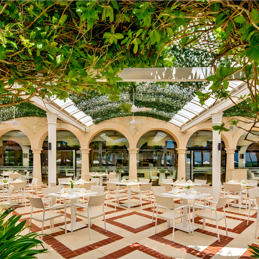 An outdoor wedding dining area with tables and chairs.