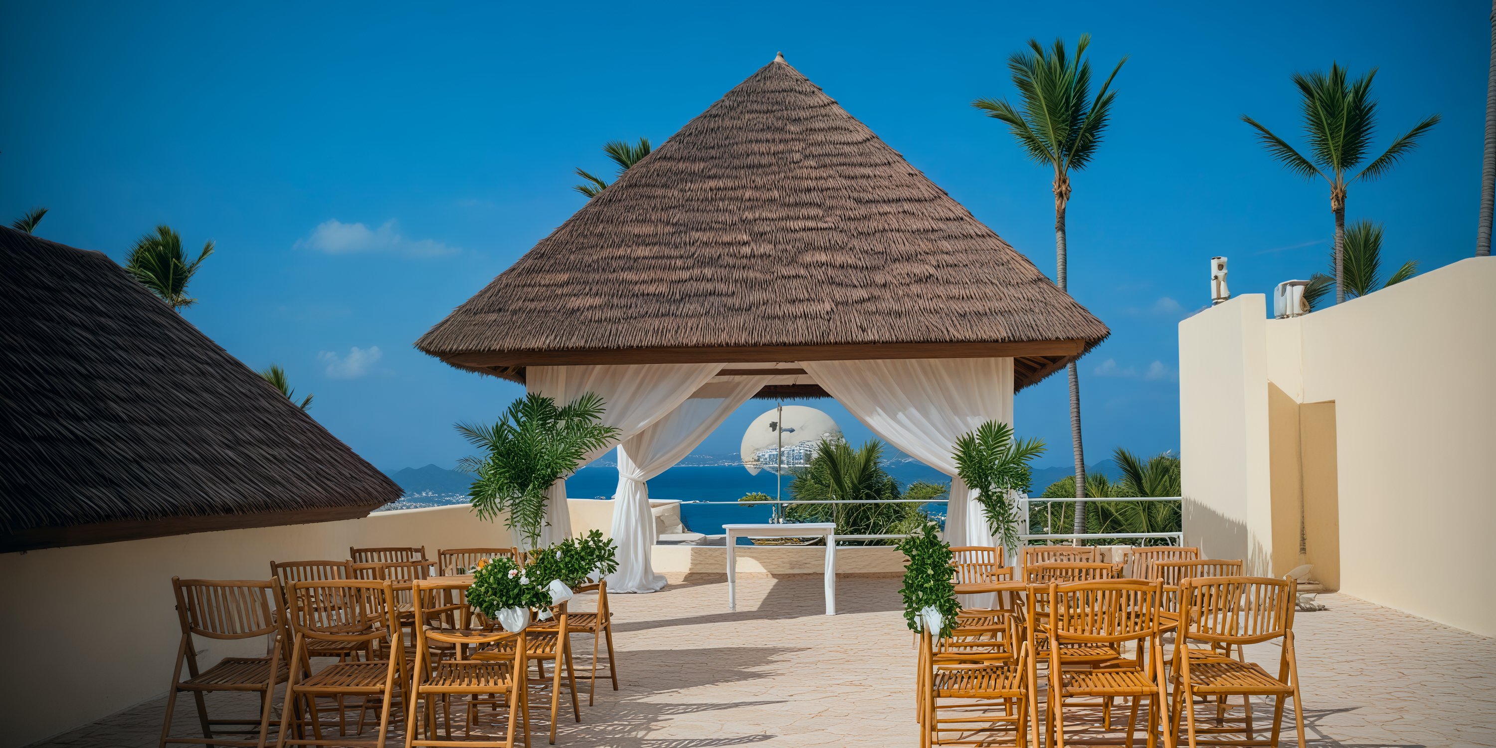 Dreams Royal Beach Punta Cana: A stunning destination wedding venue featuring wooden chairs, a charming gazebo, and breathtaking ocean views.