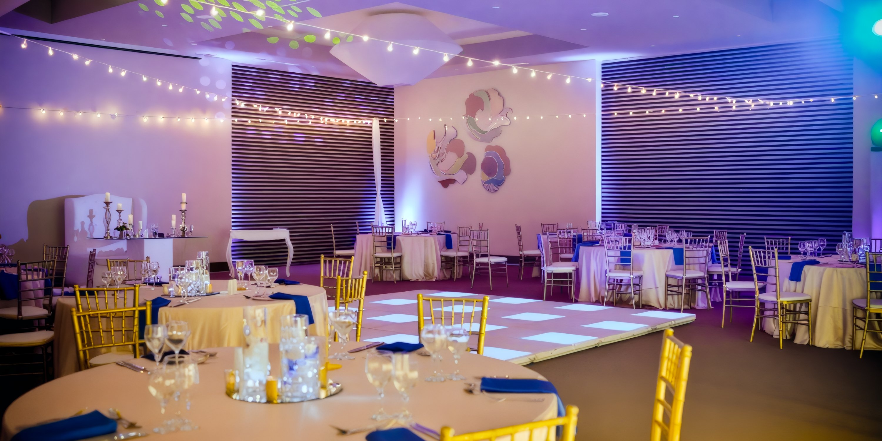 Transformed the Dreams Onyx event hall into a stunning destination wedding venue, complete with elegant tables, chairs, enchanting string lights, and a spacious dance floor.