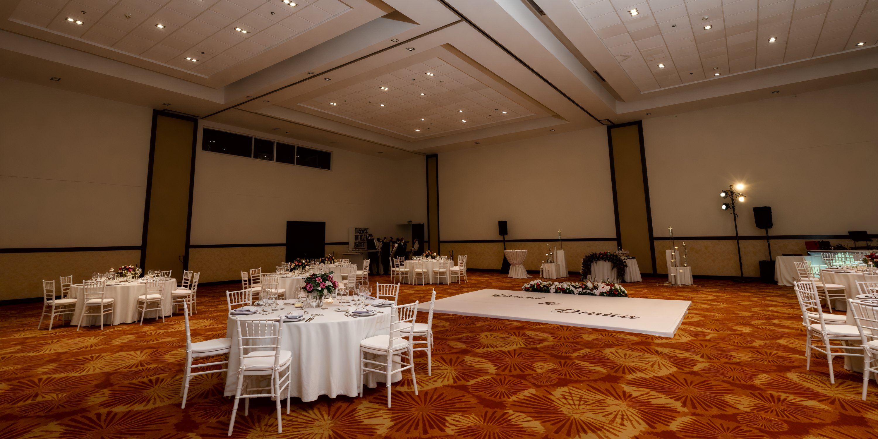Dreams Vallarta Bay boasts a spacious event hall perfect for a destination wedding, complete with tables, a dance floor, and stylish lighting.