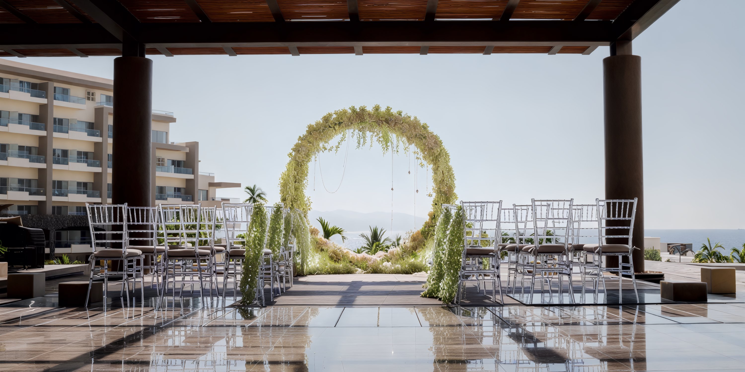 Dreams Vallarta Bay offers a stunning destination wedding with breathtaking ocean views, complete with an elegant arch and seating for guests.