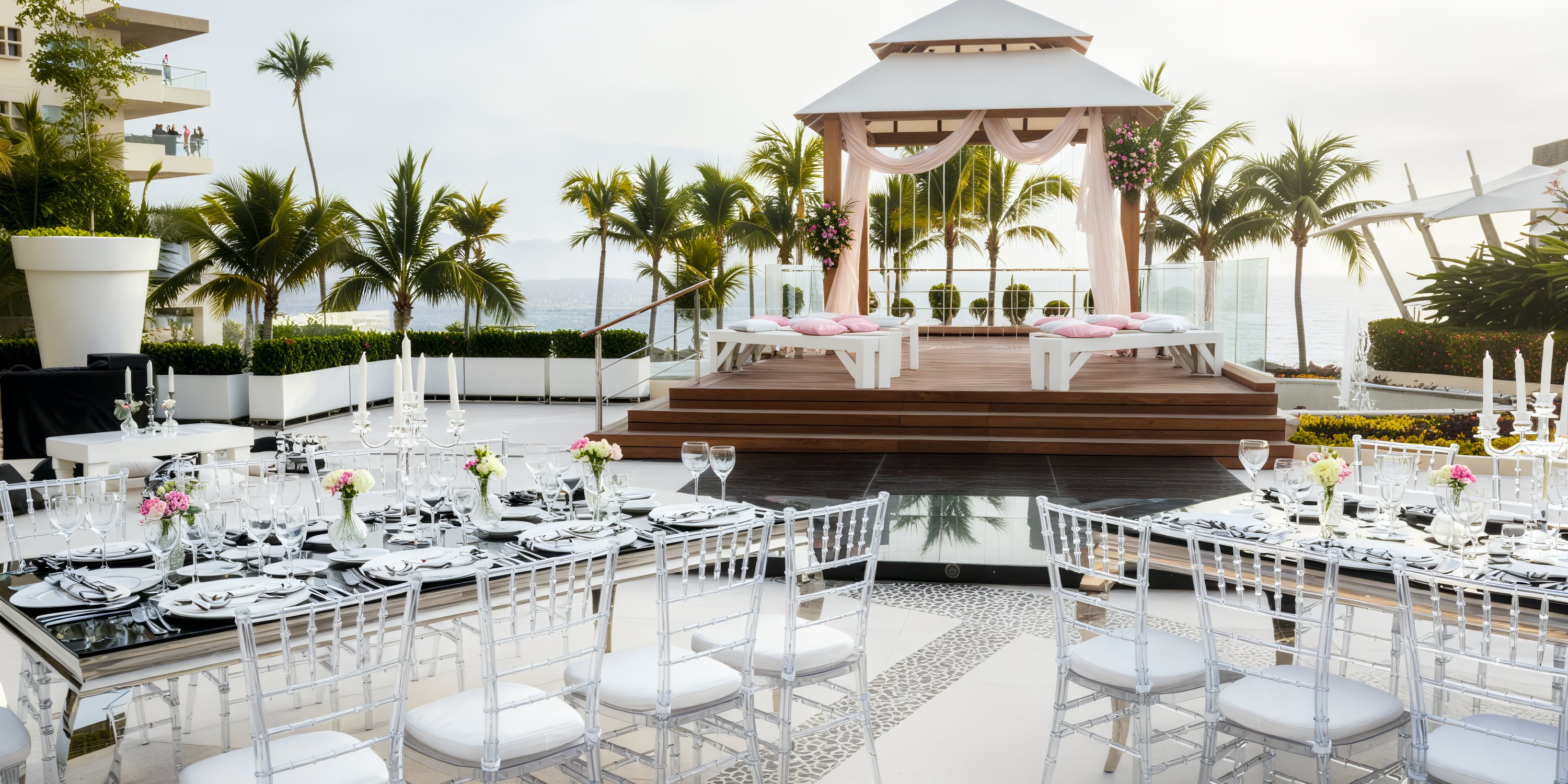 An oceanfront destination wedding setup featuring elegantly decorated tables and a charming pavilion.