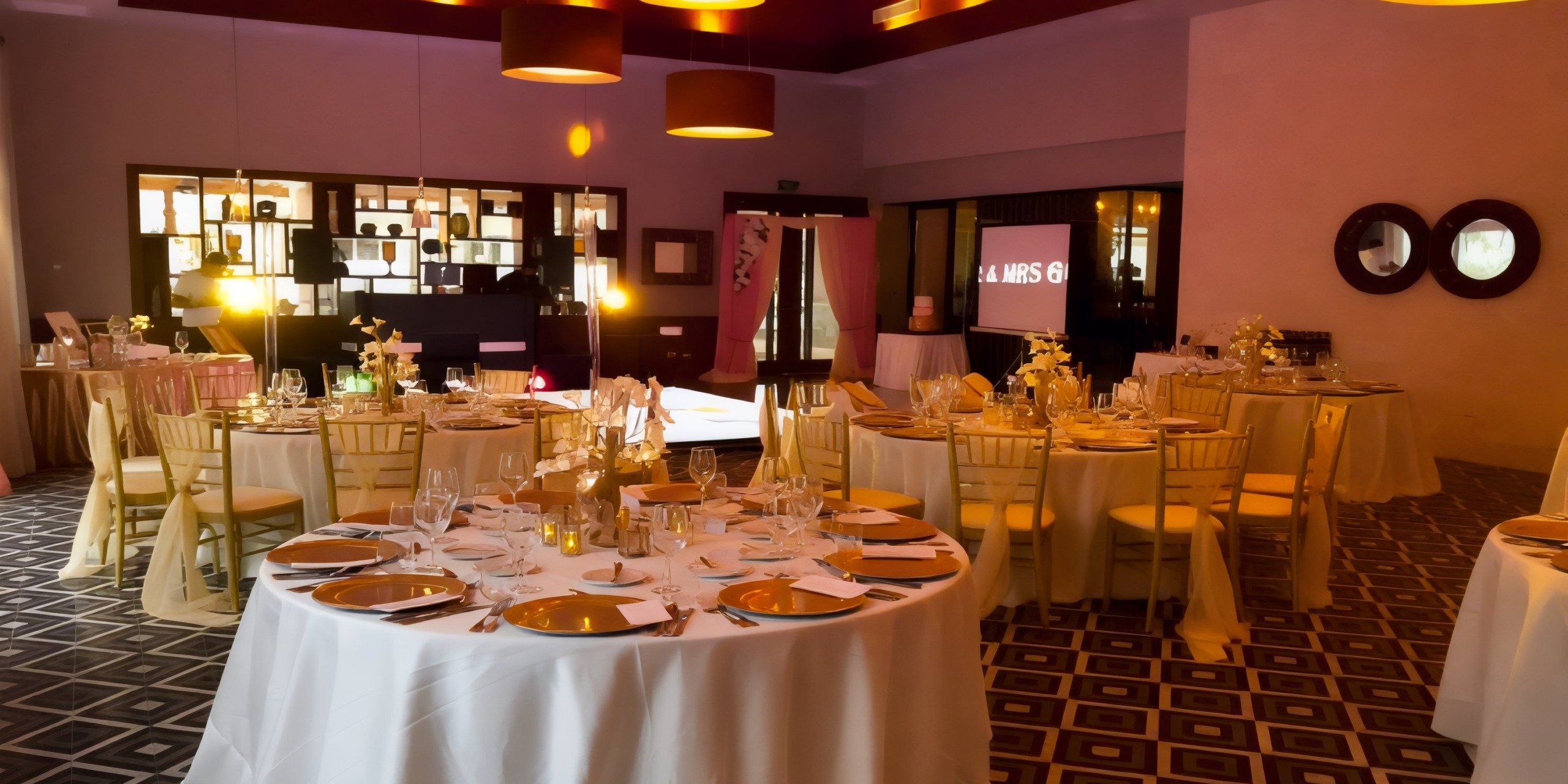 Dreams Dominicus is beautifully arranged for a destination wedding, with tables elegantly set in a warmly lit room.