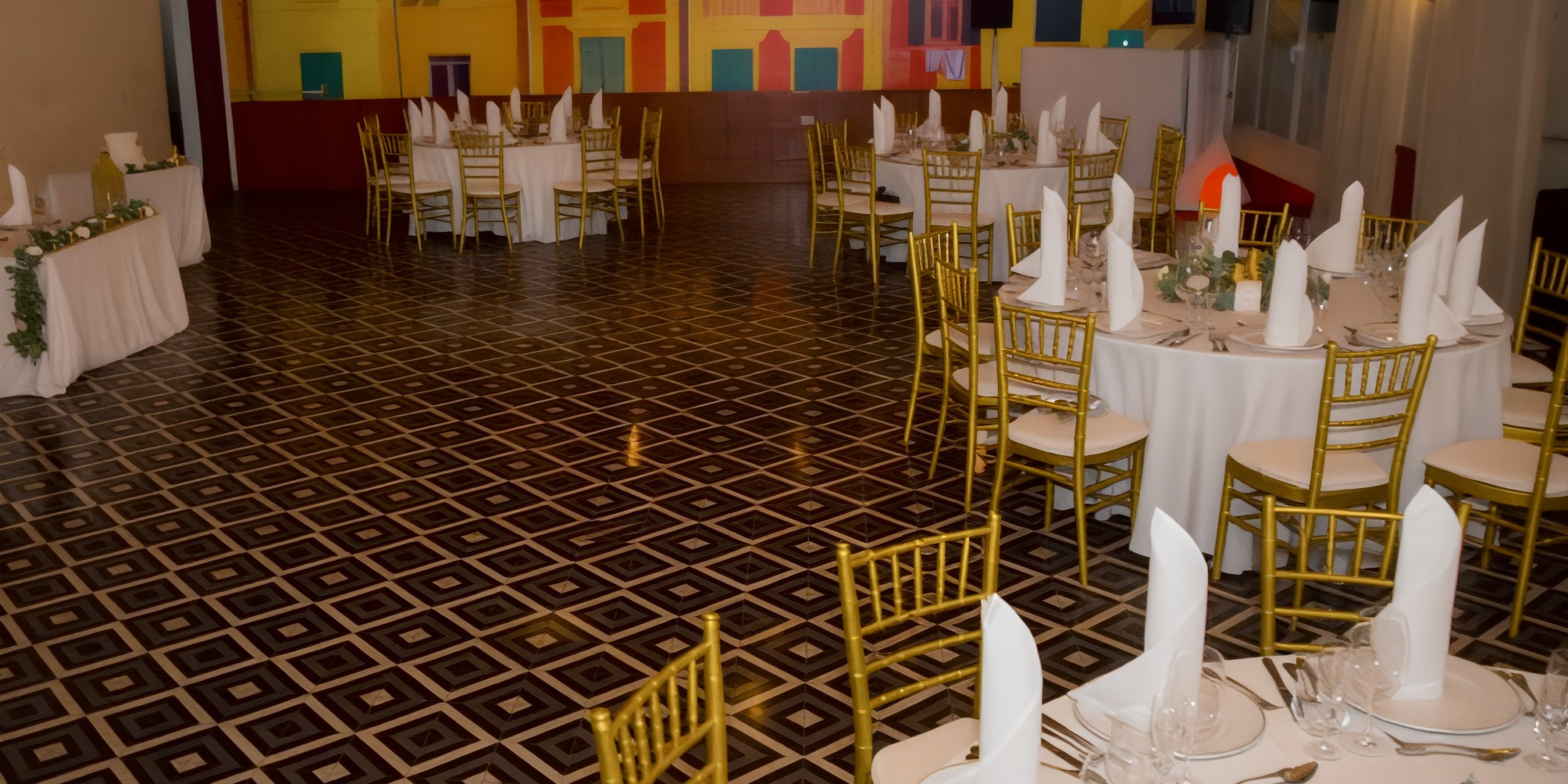 Dreams Dominicus offers a stunning banquet hall perfect for a wedding, complete with round tables adorned with white cloths and elegantly designed gold chairs. It's an ideal setting for your dream destination wedding.