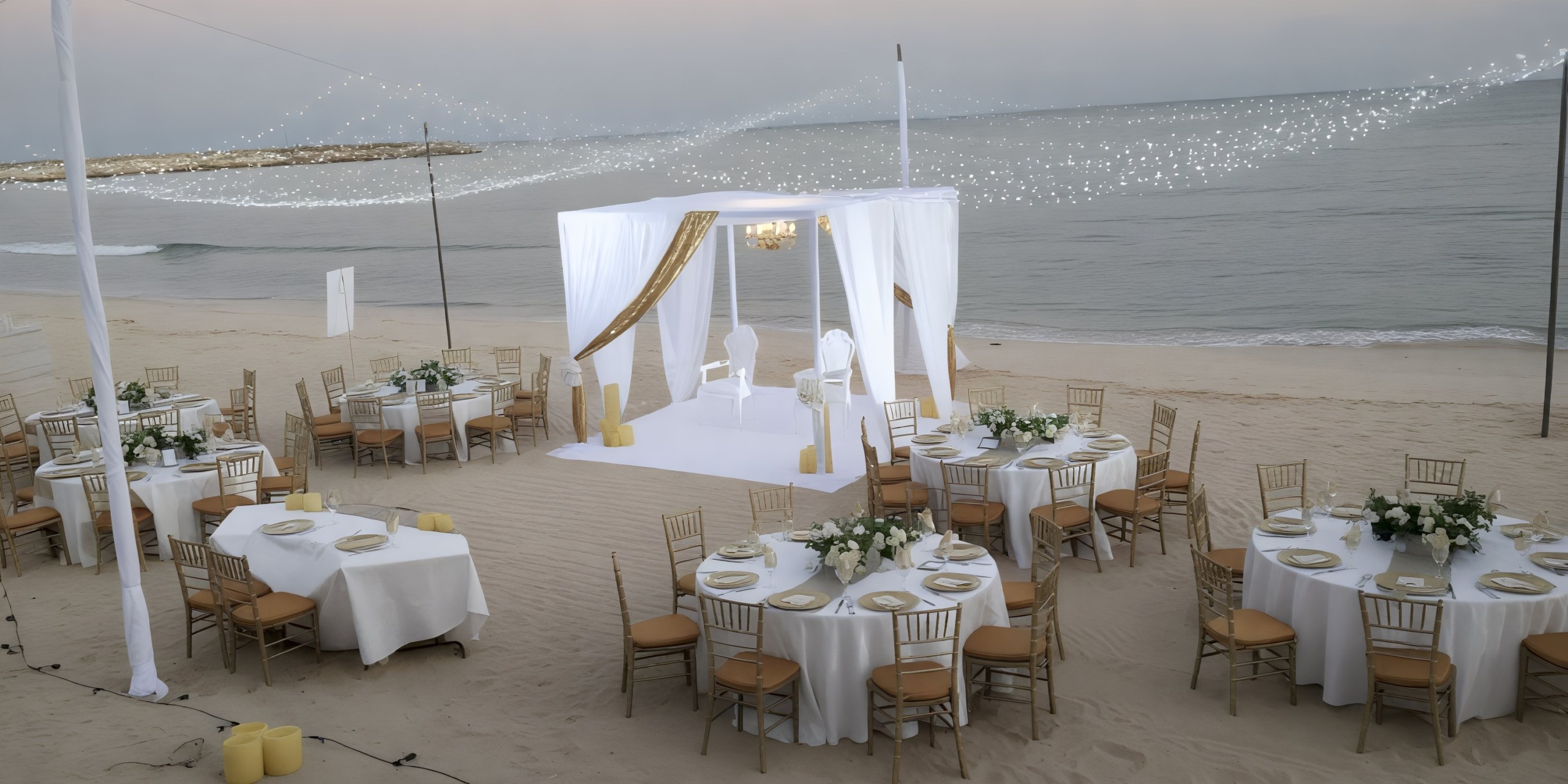 Destination wedding at Dreams Jade Riviera Cancun features elegant white tables, chairs, and a stunning sea canopy.