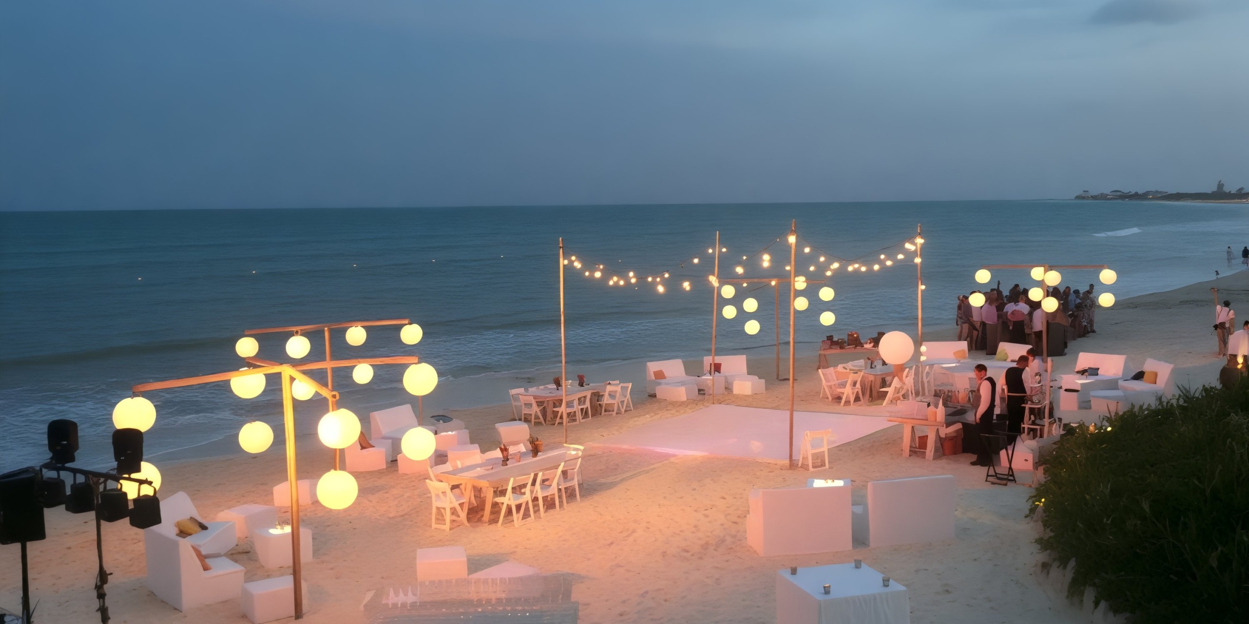 Dreams Jade Riviera Cancun: illuminated by glowing lights, with elegant white seating and tables set for a stunning destination wedding at dusk.