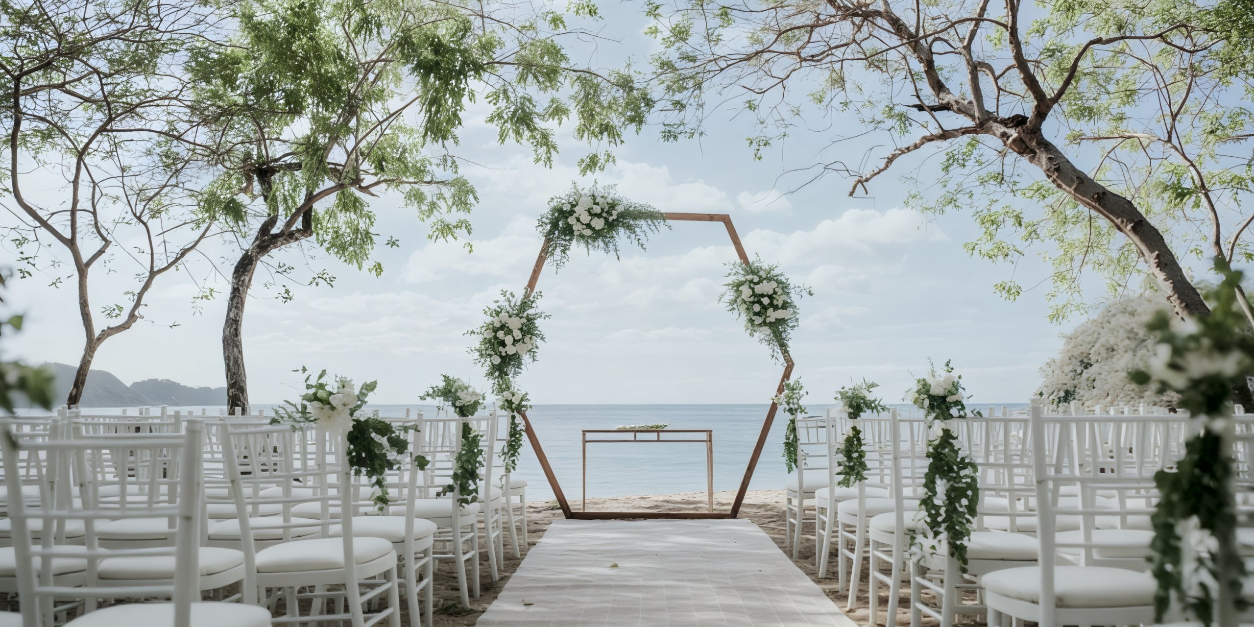 Wedding at Dreams Las Mareas features a stunning hexagonal floral arch and elegant white chairs, creating the perfect setting for a destination beach wedding.