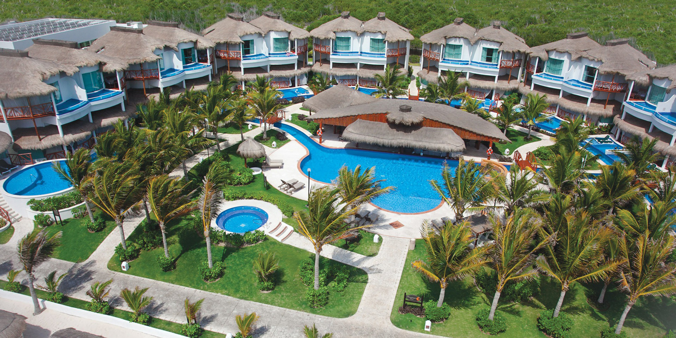 Aerial view of El Dorado Casitas Royale's resort grounds with a pool in the center