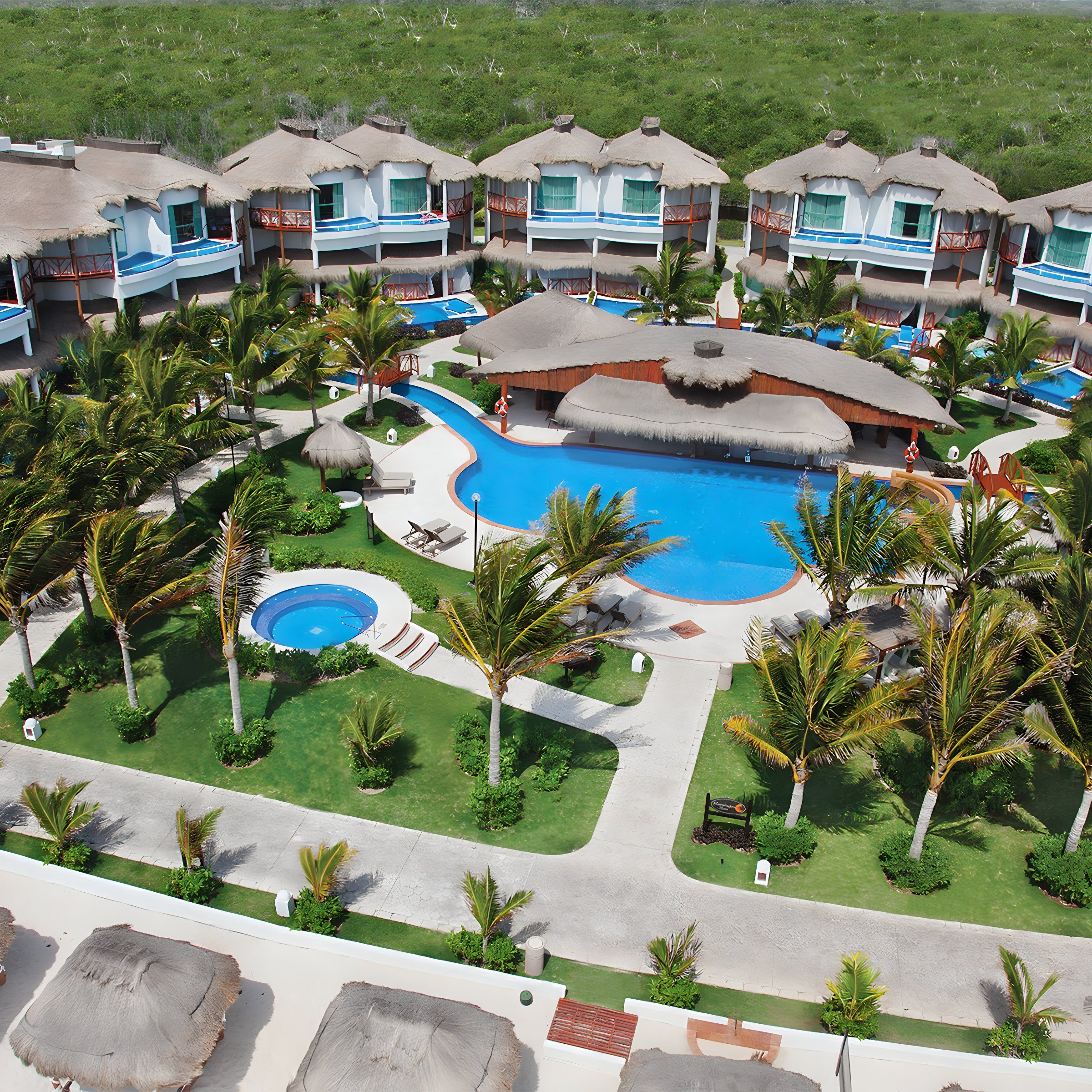 Aerial view of El Dorado Casitas Royale's resort grounds with a pool in the center